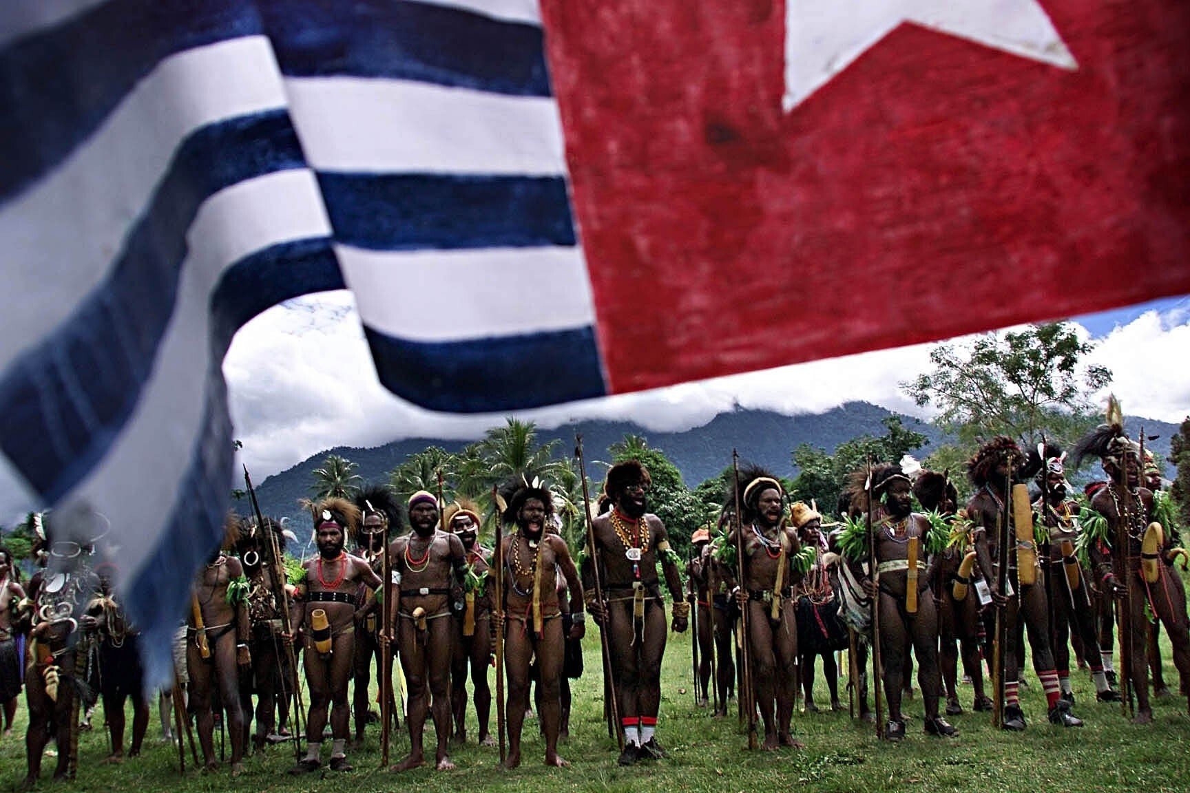 Central Highlands villagers, shown here with the Morning Star flag in the West Papua capital, have been fighting to recover their ancestral lands for 50 years. Picture: Getty Images