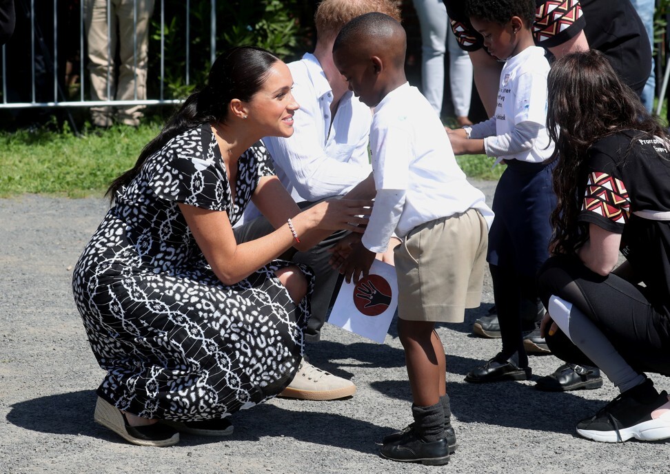 The Duchess of Sussex, Meghan, speaks with a child in Nyanga township while visiting Cape Town, South Africa, in 2019. Photo: Reuters