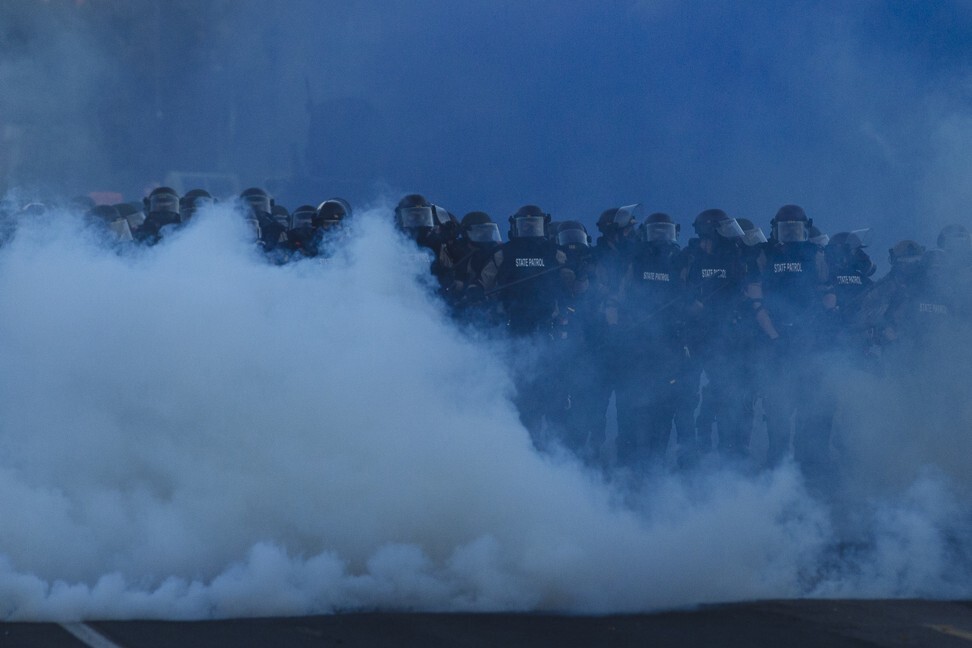 Riot police officers walk through tear gas during a protest outside the 5th Police Precinct in Minneapolis, the United States, on May 30. Photo: Xinhua