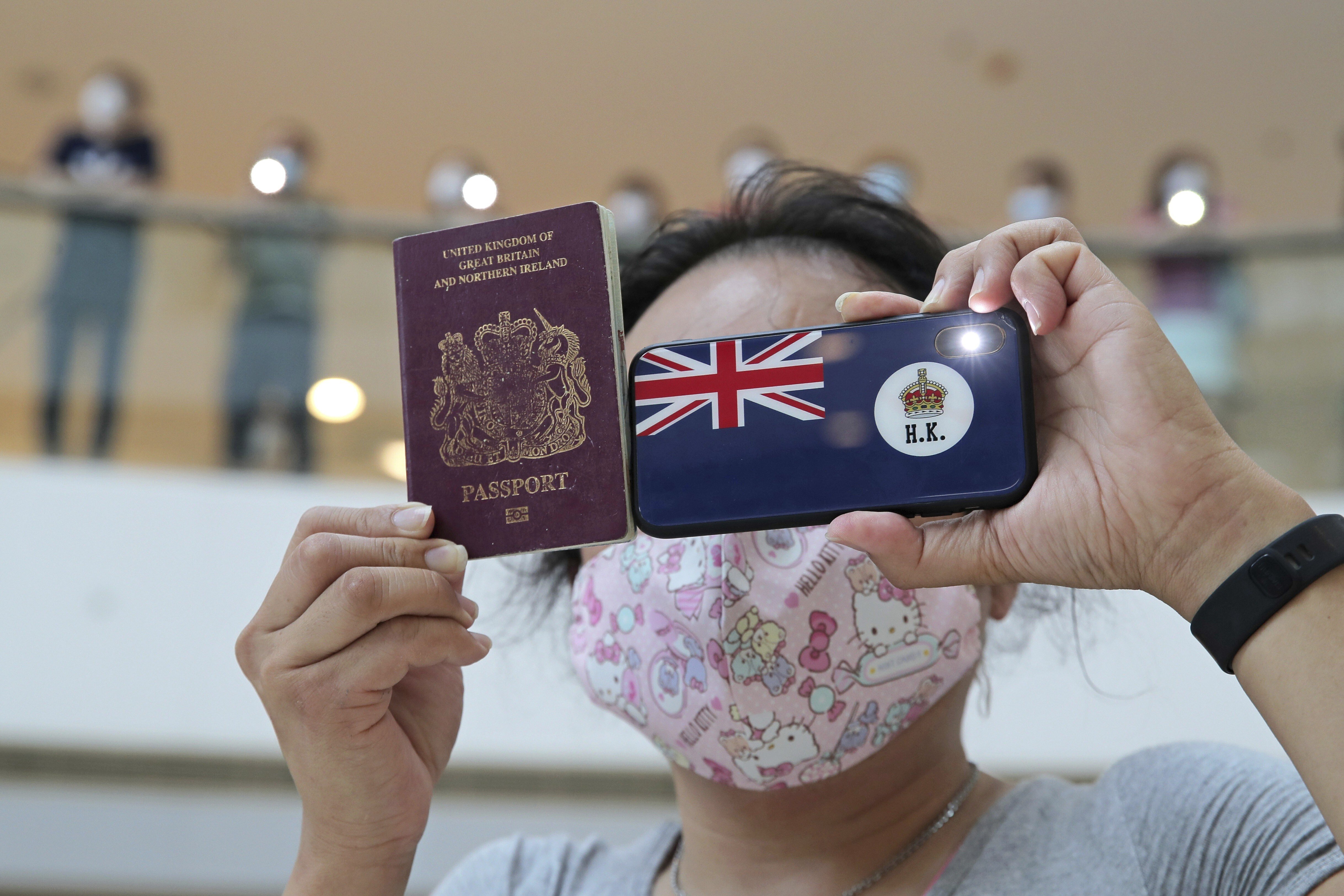 A protester in Hong Kong holds a British National (Overseas) passport during a protest against China’s national security legislation for the city. Photo: AP