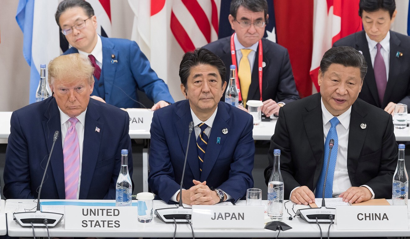 Japan's Prime Minister Shinzo Abe sits between US President Donald Trump with and China's President Xi Jinping at the G20 Summit in Osaka in June 2019. Photo: AFP