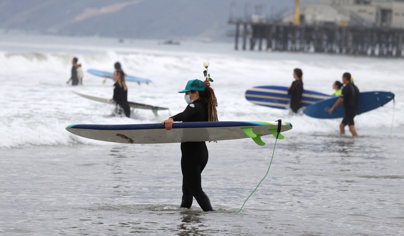 A woman walks into the surf at The Black Girls Surf paddle-out in Santa Monica, California, on June 5, 2020. Photo: Reuters