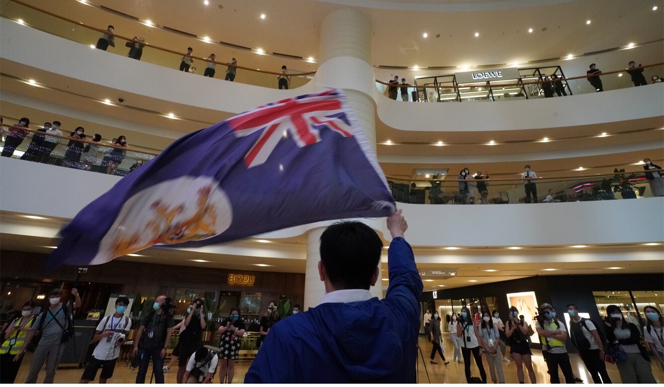 An anti-government protester waves the flag of colonial Hong Kong during a rally at the Pacific Place shopping centre. Photo: Felix Wong