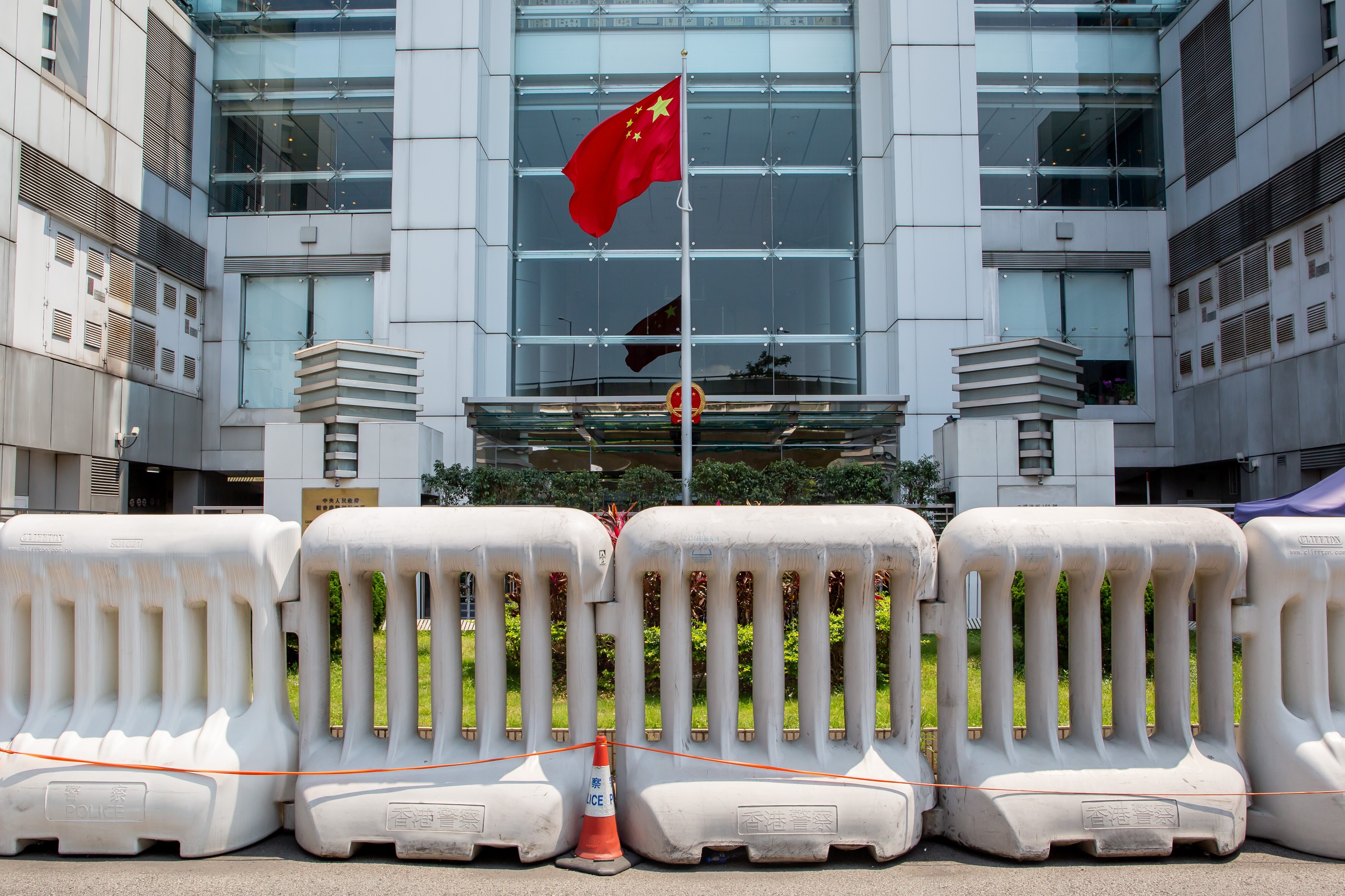 The Chinese flag, behind barriers outside the central government’s liaison office in Hong Kong in April. Photo: Bloomberg