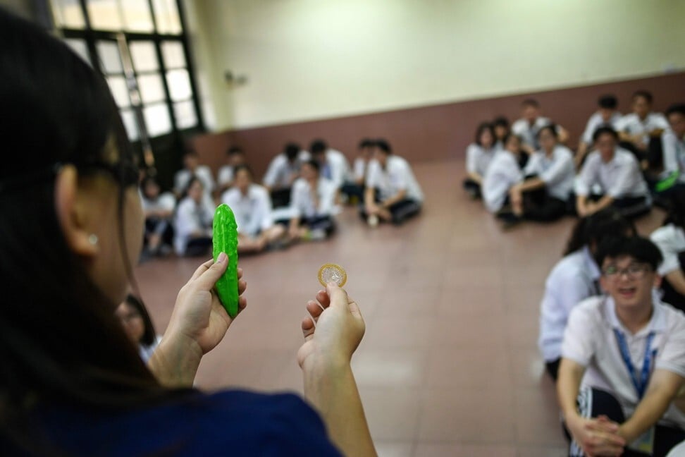 Trinh Huong Ly shows high school students how to use a condom at the Nguyen Tat Thanh High School in Hanoi. Photo: AFP
