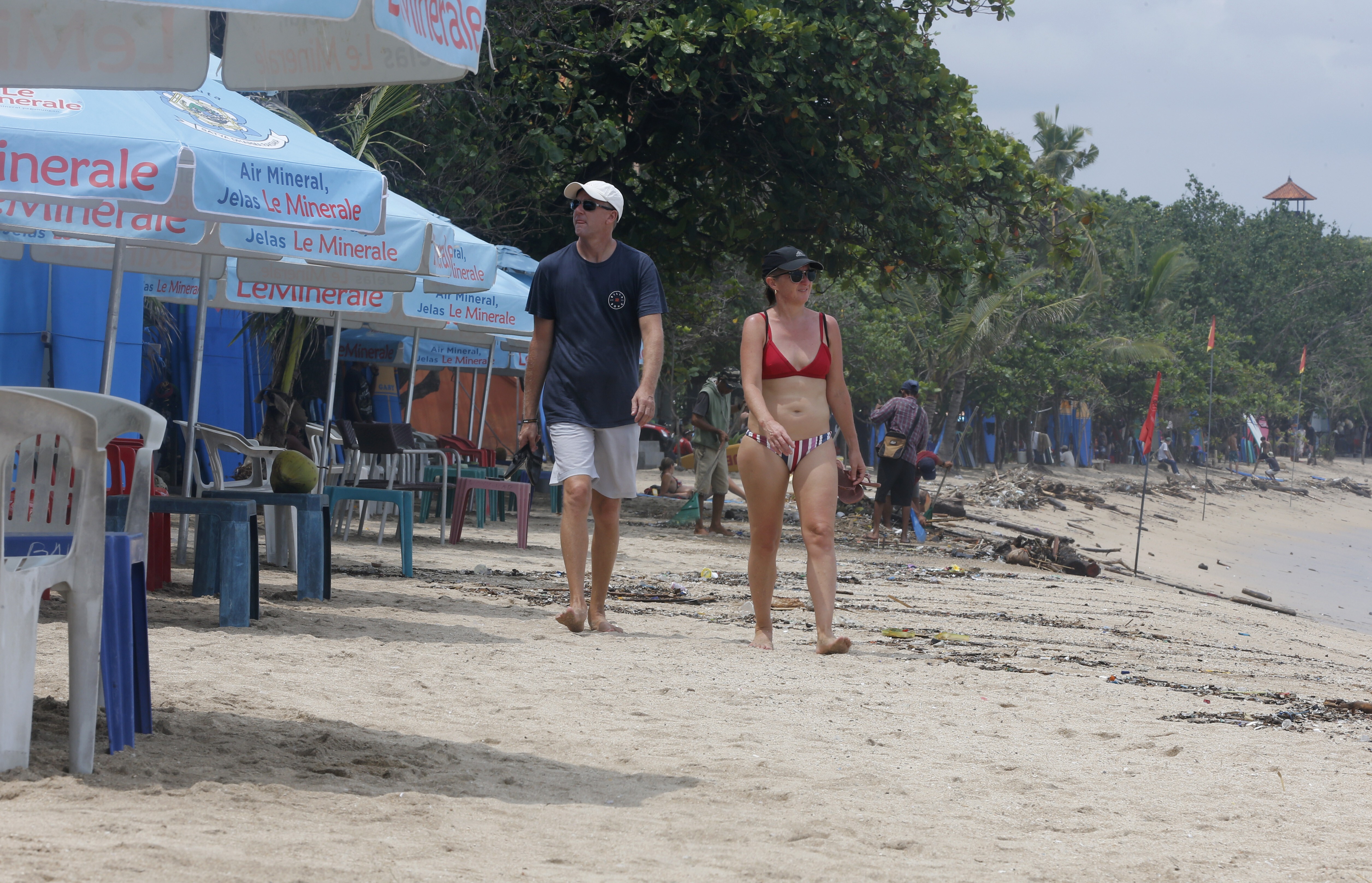 Foreigners walk along an empty Kuta Beach in Bali amid the coronavirus pandemic in March. Photo: AP