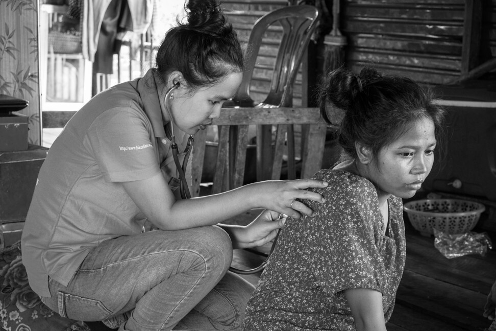 Dr Hun Thourida pays a house call to a woman unable to reach the clinic. She has been treating the 28-year-old for Pott’s disease – tuberculosis of the spine – that could have resulted in paralysis. The woman lives with her young daughter; her mother, who has Parkinson’s; her father, who lost a leg to gangrene; her sister, who also has TB; and her sister’s husband, the family’s sole breadwinner. Her own husband disappeared when she became unwell. Photo: Gary Jones