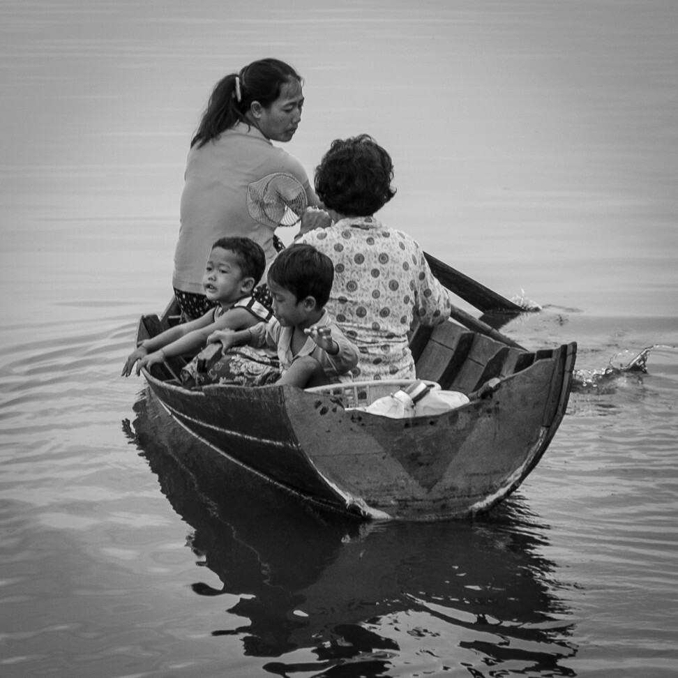 Having seen a doctor, patients paddle a rowing boat home. Though many fishing families have access to boats with outboard motors, for those living farthest from land, travel for a medical emergency could cost up to 200,000 riel in diesel fuel, a prohibitive amount for many families. TLC travels to those most in need, and provides transport to faraway hospitals in urgent cases. Photo: Gary Jones