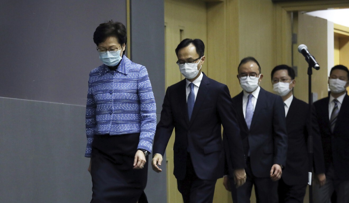 Chief Executive Carrie Lam, followed by Secretary for Civil Service Patrick Nip and other ministers, walks into a press conference to introduce Hong Kong’s newly appointed principal officials on April 22. Nip raised eyebrows by telling civil servants that they serve both the city and the country as a whole. Photo: AP