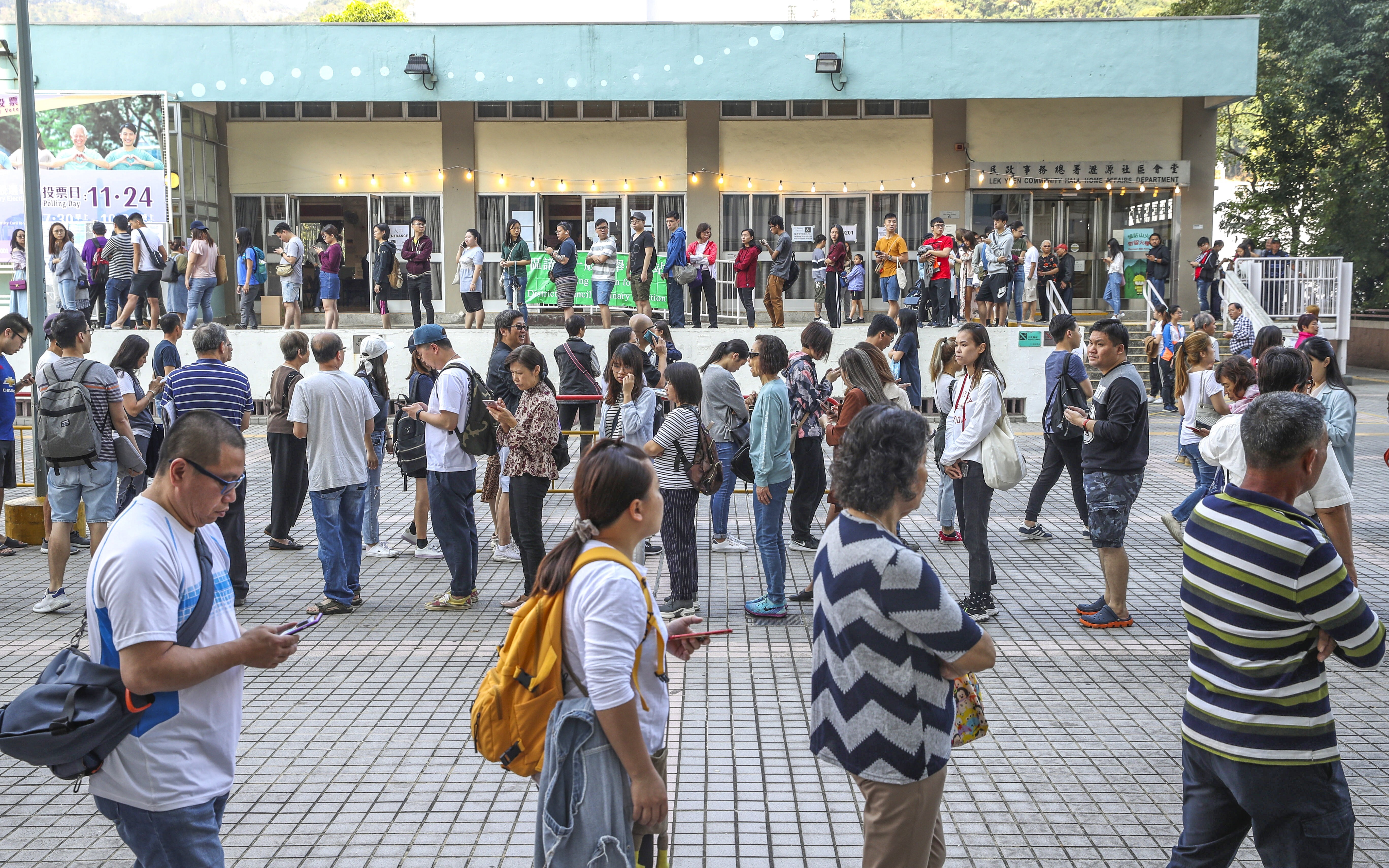 People queue up outside a polling station to cast their ballots at the district council elections in Hong Kong in 2019. Photo: Winson Wong