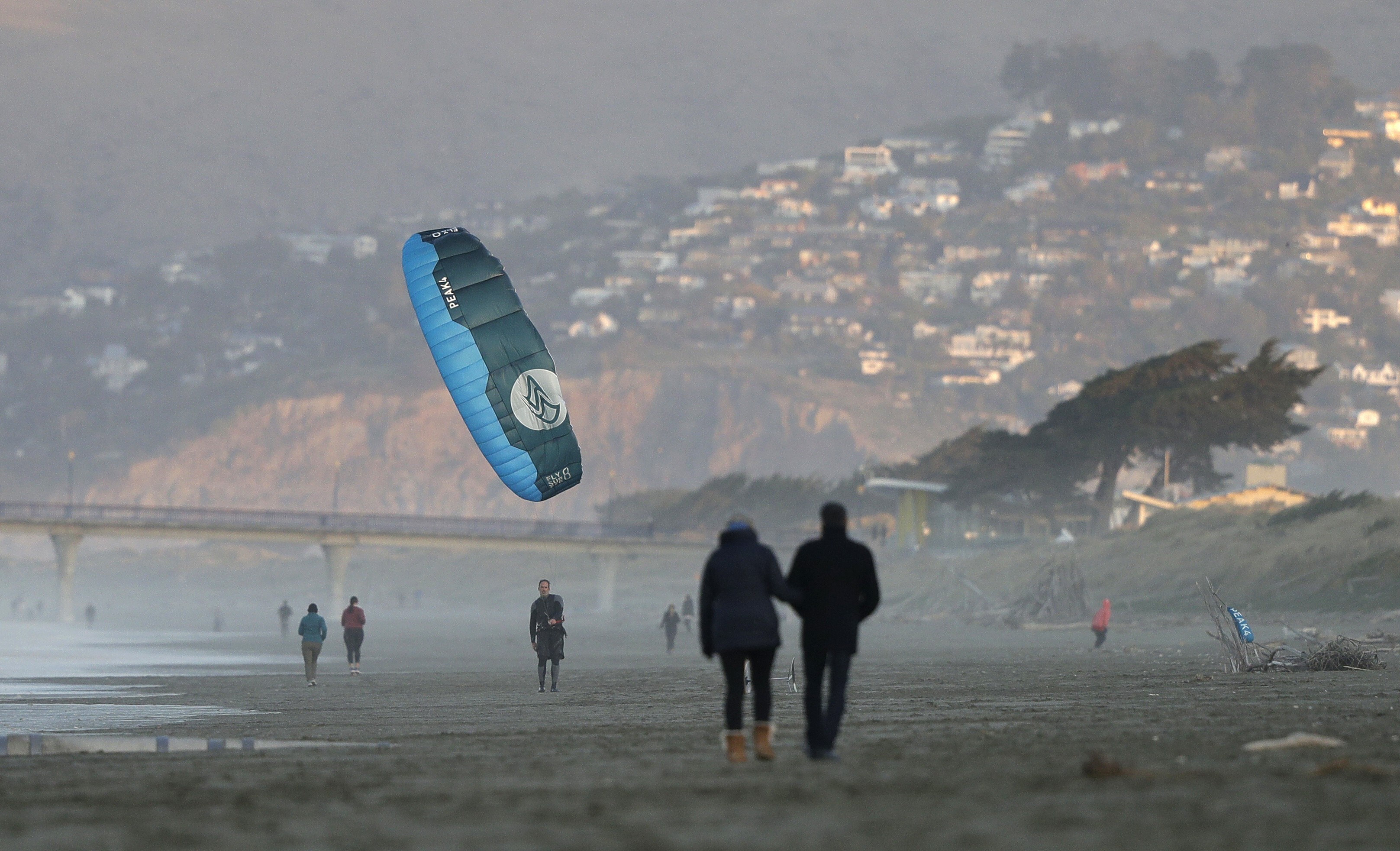A windsurfer reels in his kite at New Brighton Beach in Christchurch, New Zealand, a day after Prime Minister Jacinda Ardern announced the removal of most coronavirus restrictions. Photo: AP