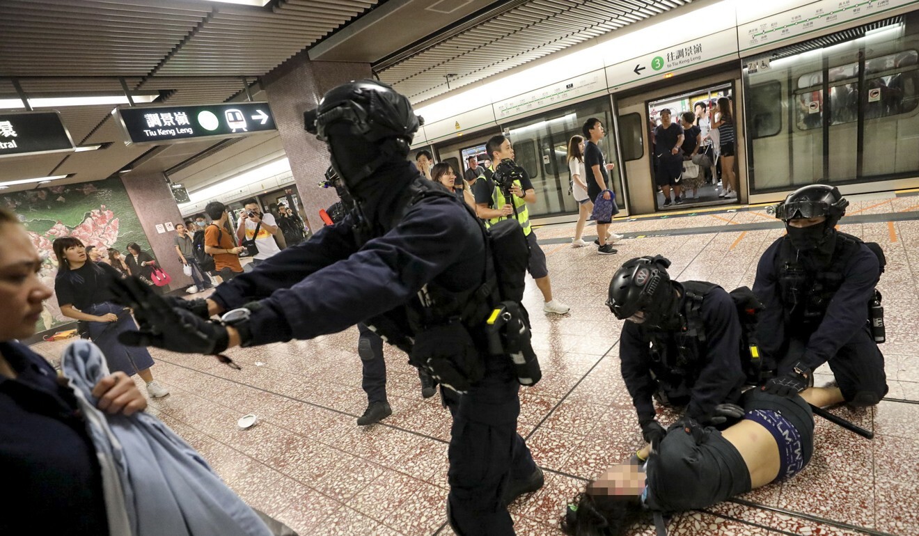 Riot officers arrest an anti-government protester in Prince Edward MTR station on August 31. Photo: Handout