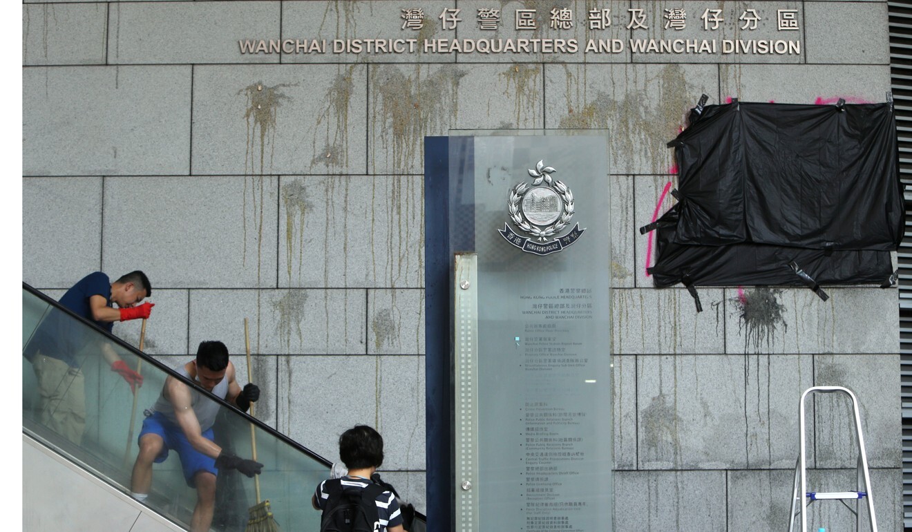 Police volunteers clean up police headquarters in Wan Chai after a protest on June 22 last year. Photo: Winson Wong