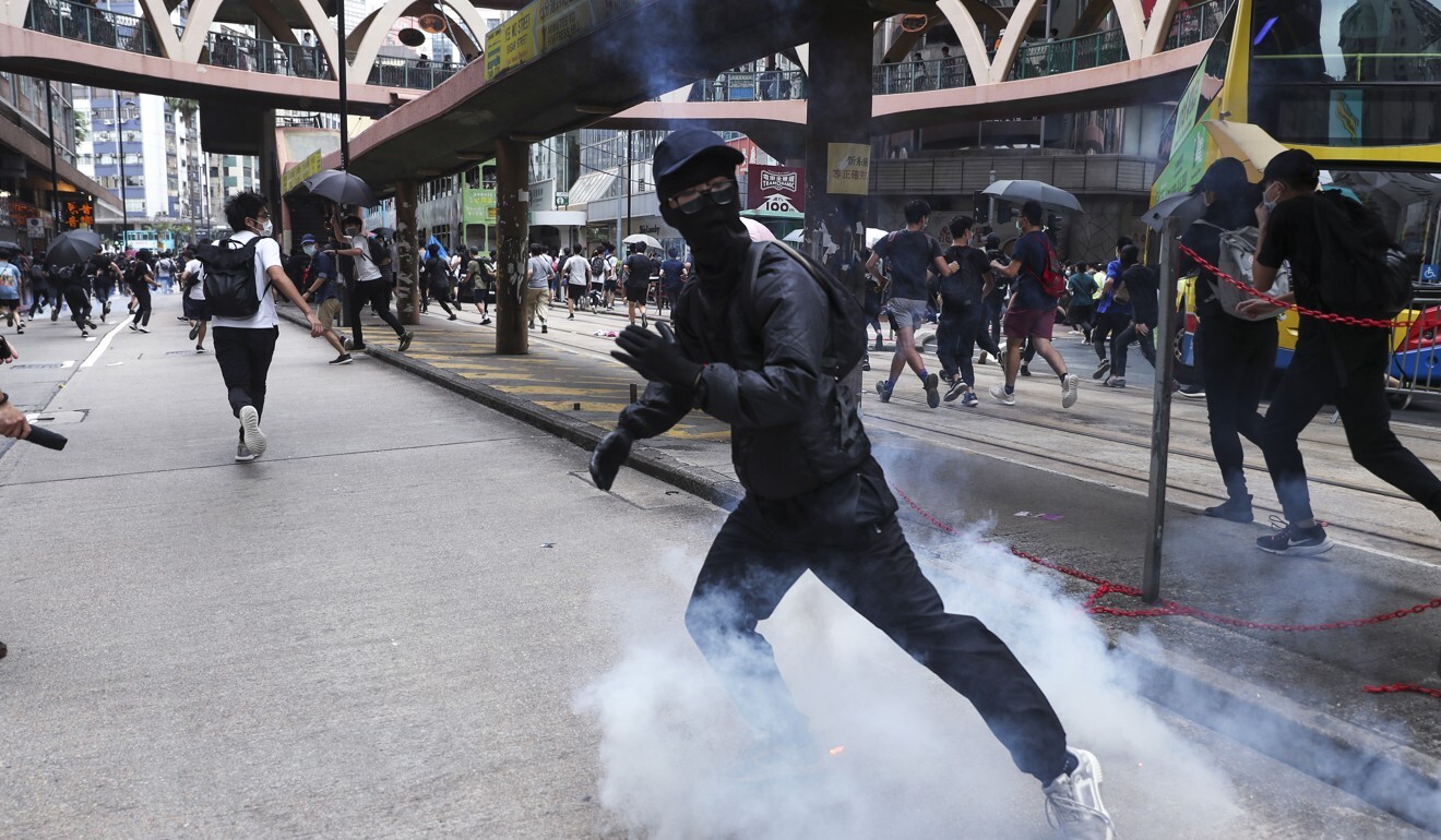 Police fire tear gas at protesters on the streets in Causeway Bay. Photo: Sam Tsang