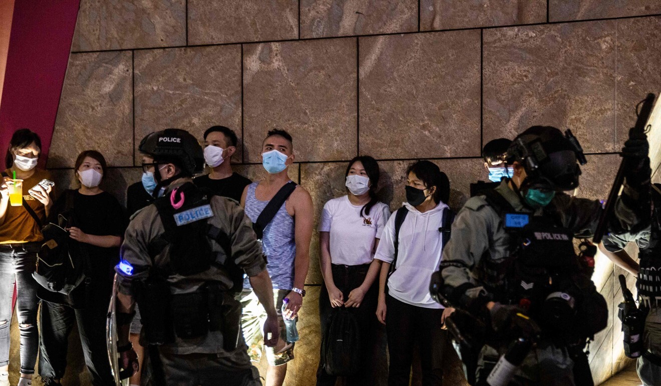 People are detained by police as protesters gathered in Mong Kok on Friday. Photo: AFP