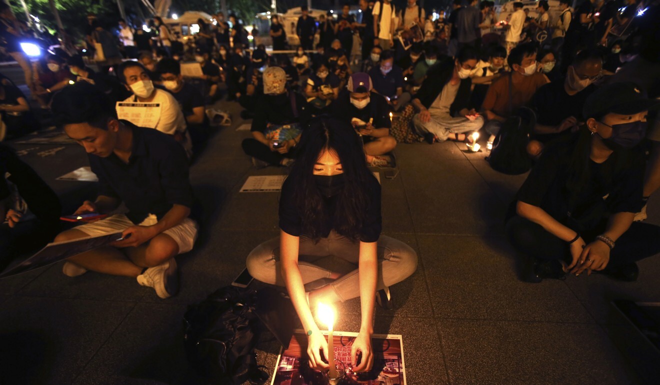Hong Kong and Taiwanese supporters hold slogans reading “Evil National Security Legislation. The Escaped Prisoner Regulations 2.0” during a protest in Taipei last month. Photo: AP