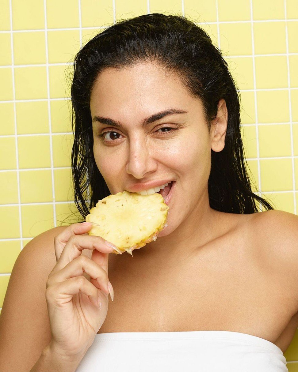 Huda eating pineapple in the bathroom. Photo: Instagram