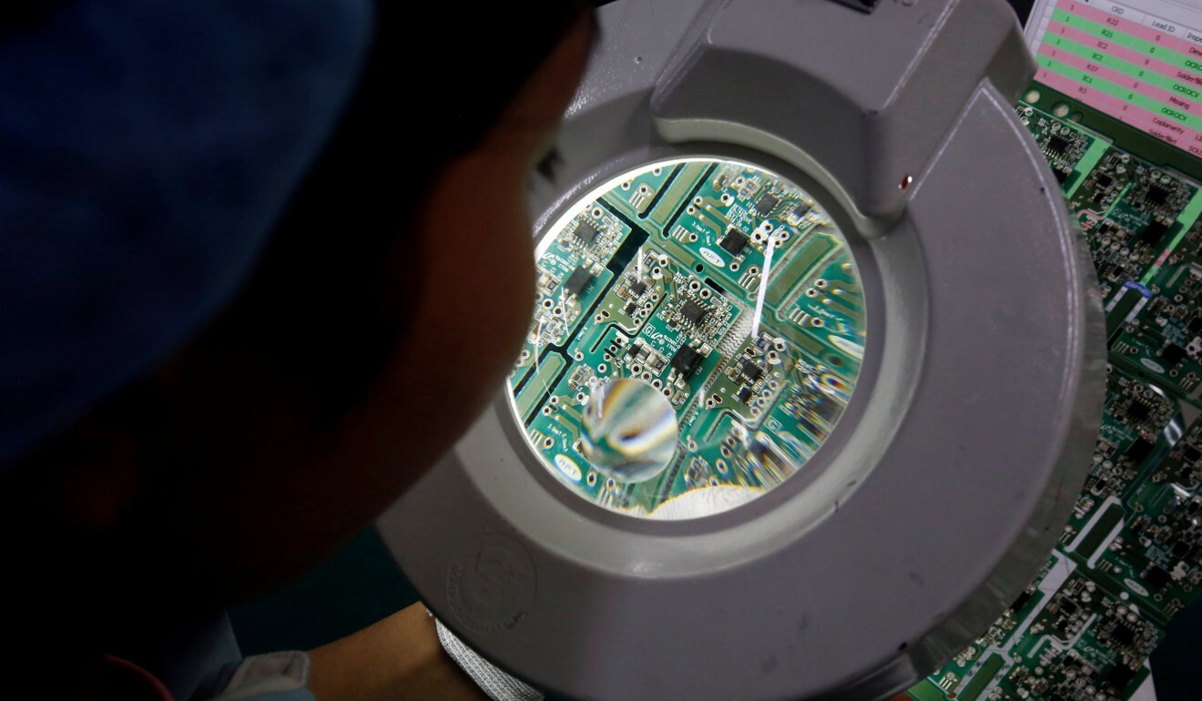 A woman inspects a circuit board at Manutronics Factory in Bac Ninh province, Vietnam. Photo: Reuters