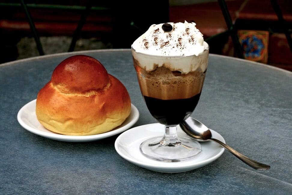 Coffee and whipped cream granita served with a bun.