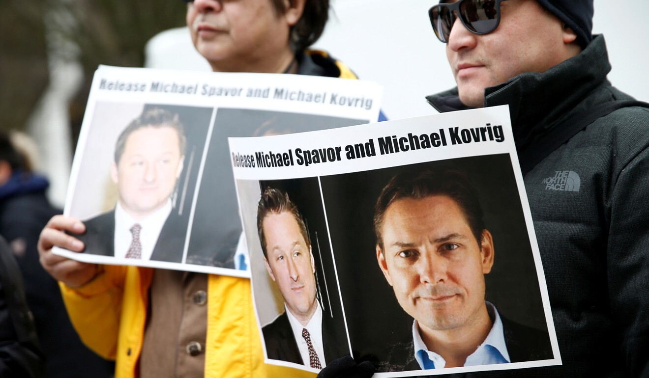 People hold signs calling for China to release Canadian detainees Michael Spavor and Michael Kovrig. Photo: Reuters