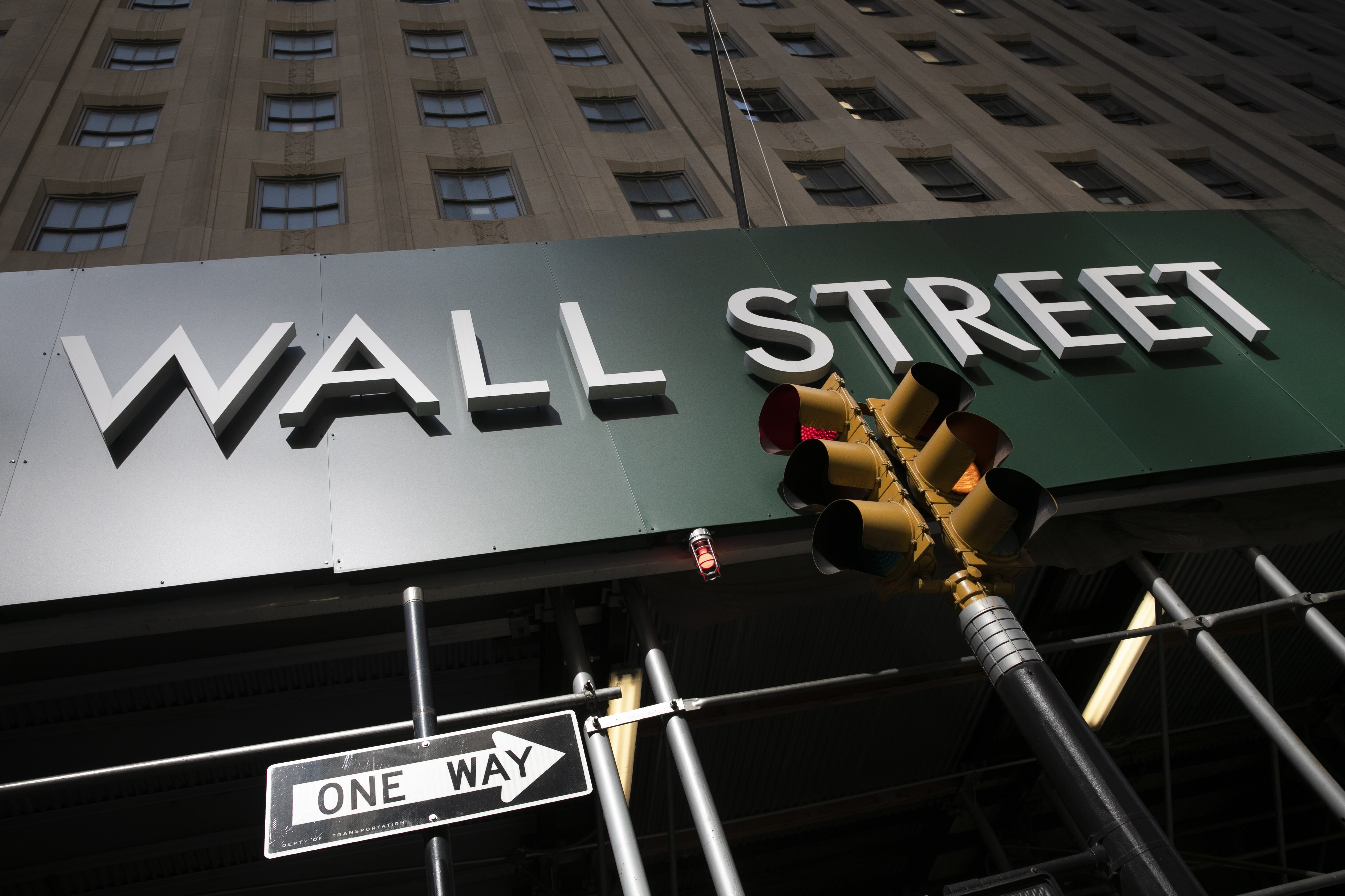 A sign for a Wall Street building is seen on June 16. Photo: AP