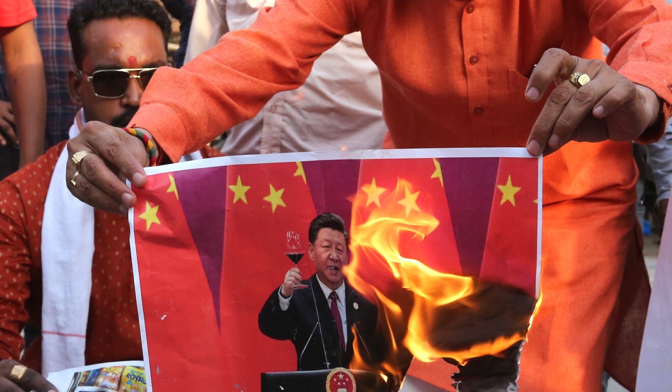 Indians burn images of Chinese President Xi Jinping after 20 Indian troops were killed during a clash with Chinese forces in the Galwan Valley of the eastern Ladakh region. Photo: EPA