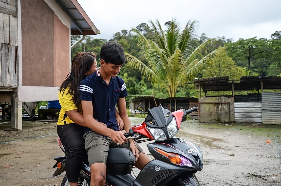 Iris, 16, and Uwix Japan, 19, were married in 2018. Japan says their parents were “very happy” when they wanted to get married. Now, they often go for dates on his motorbike. Photo: Sherlyn Seah