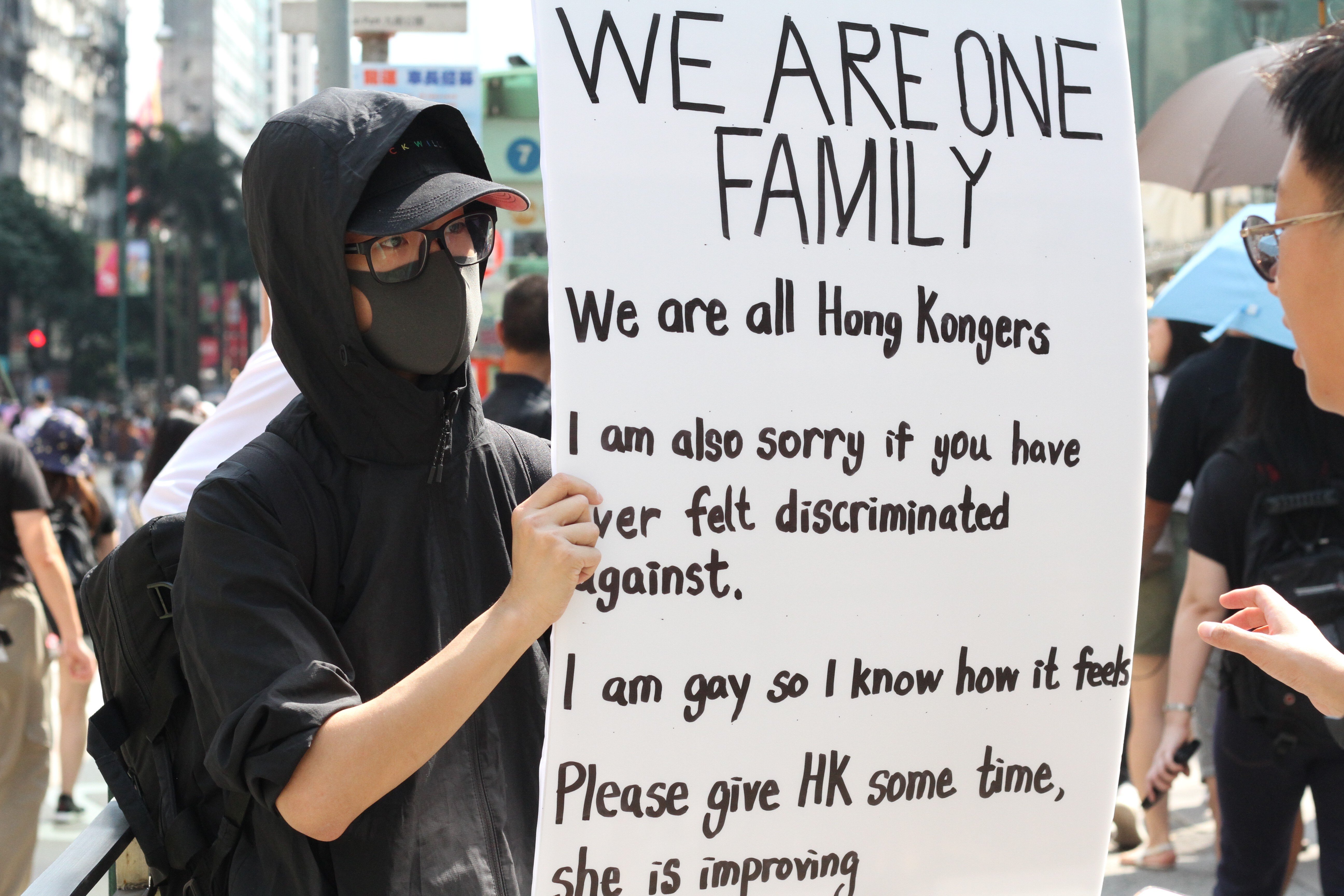 A protester stands in front of Hong Kong’s largest mosque, Kowloon Mosque, and holds a banner to show support for ethnic minorities last October, after a police cannon sprayed blue dye on the mosque and people outside. Photo: Raquel Carvalho