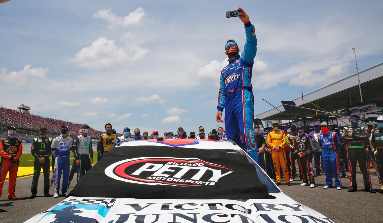 Bubba Wallace takes a selfie while standing on his car. Photo: DPA