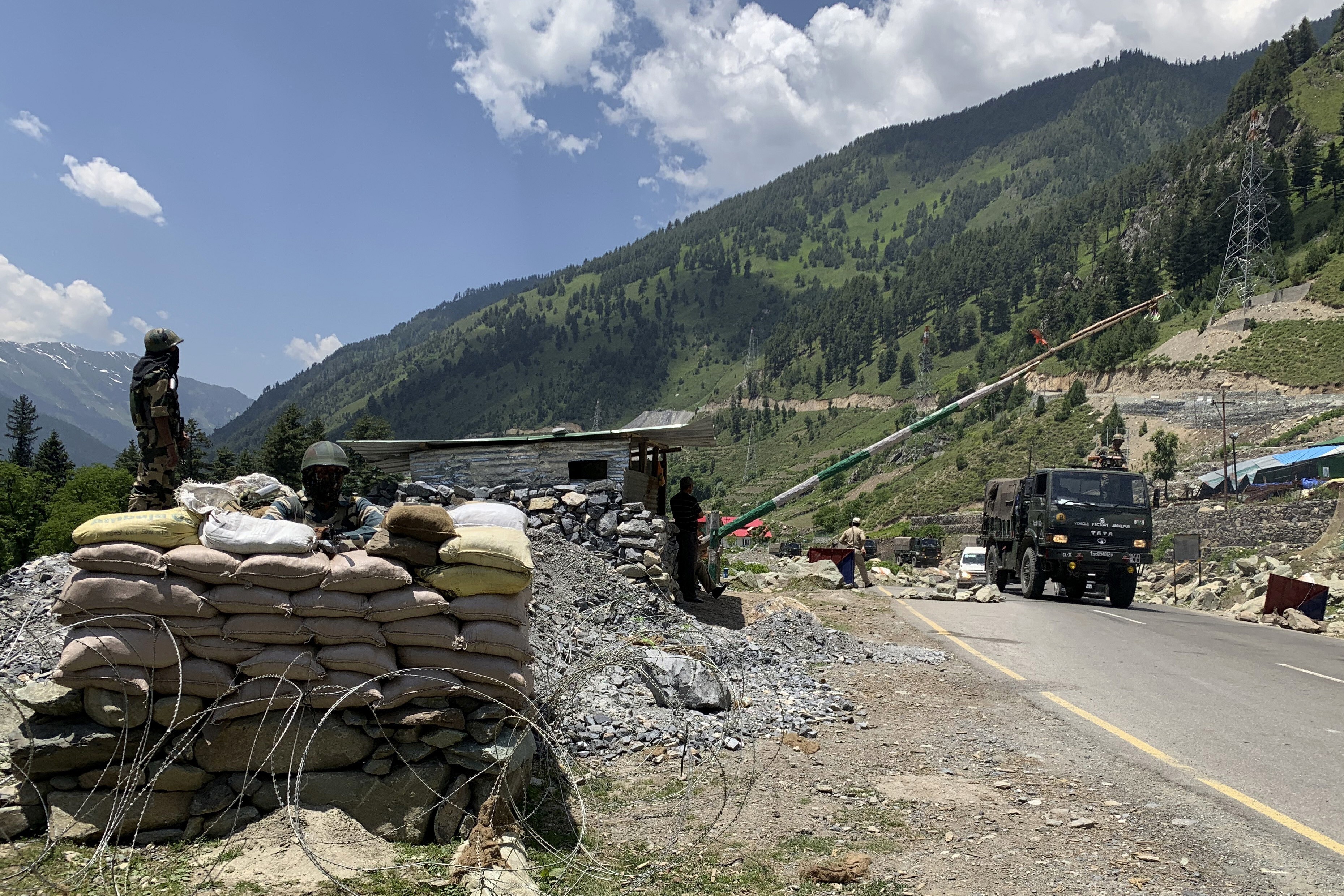 Indian soldiers keep guard as an army convoy moves on the Srinagar-Ladakh highway at Gagangeer, India on June 18. India has cautioned China against making “exaggerated and untenable claims” to the Galwan valley area even as both nations tried to end the stand-off. Photo: AP
