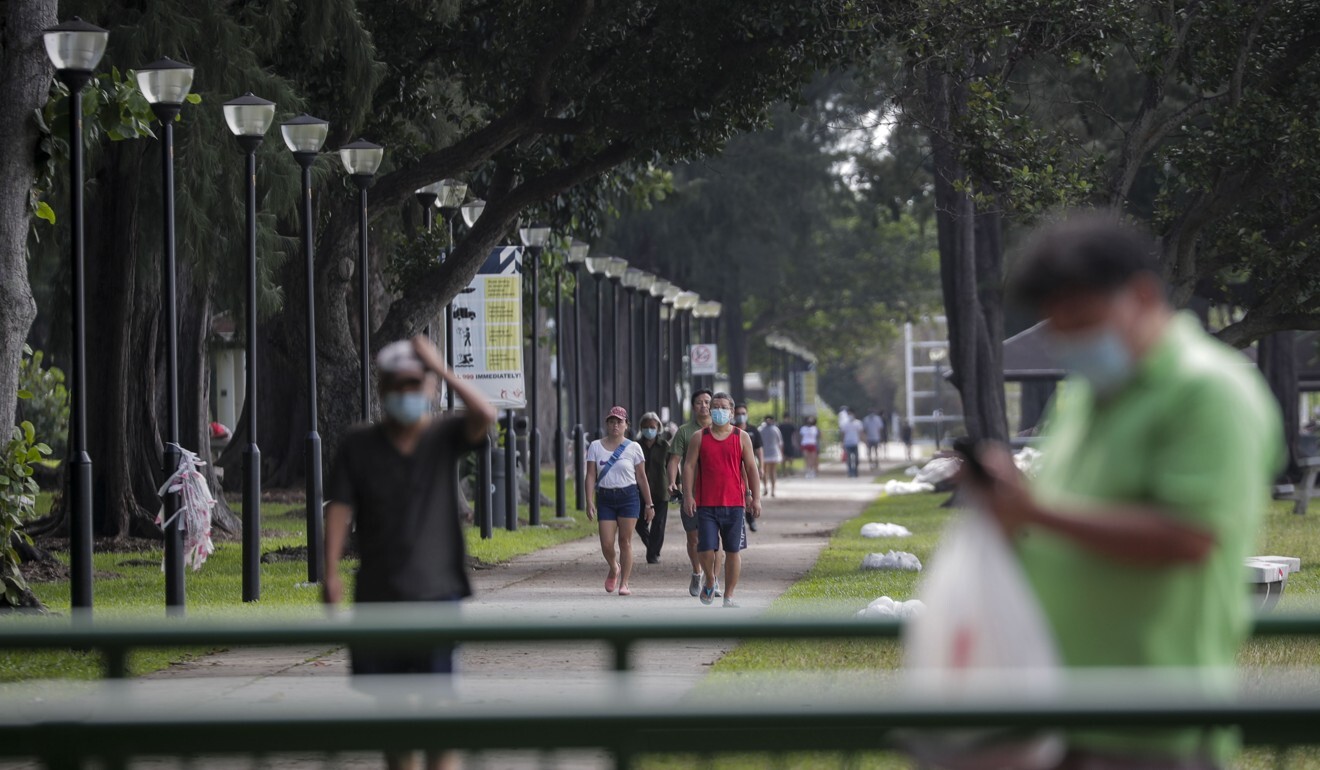 Singaporeans wearing masks walk along a pathway at the East Coast Park after circuit breaker measures were further lifted on June 19. Photo: EPA-EFE