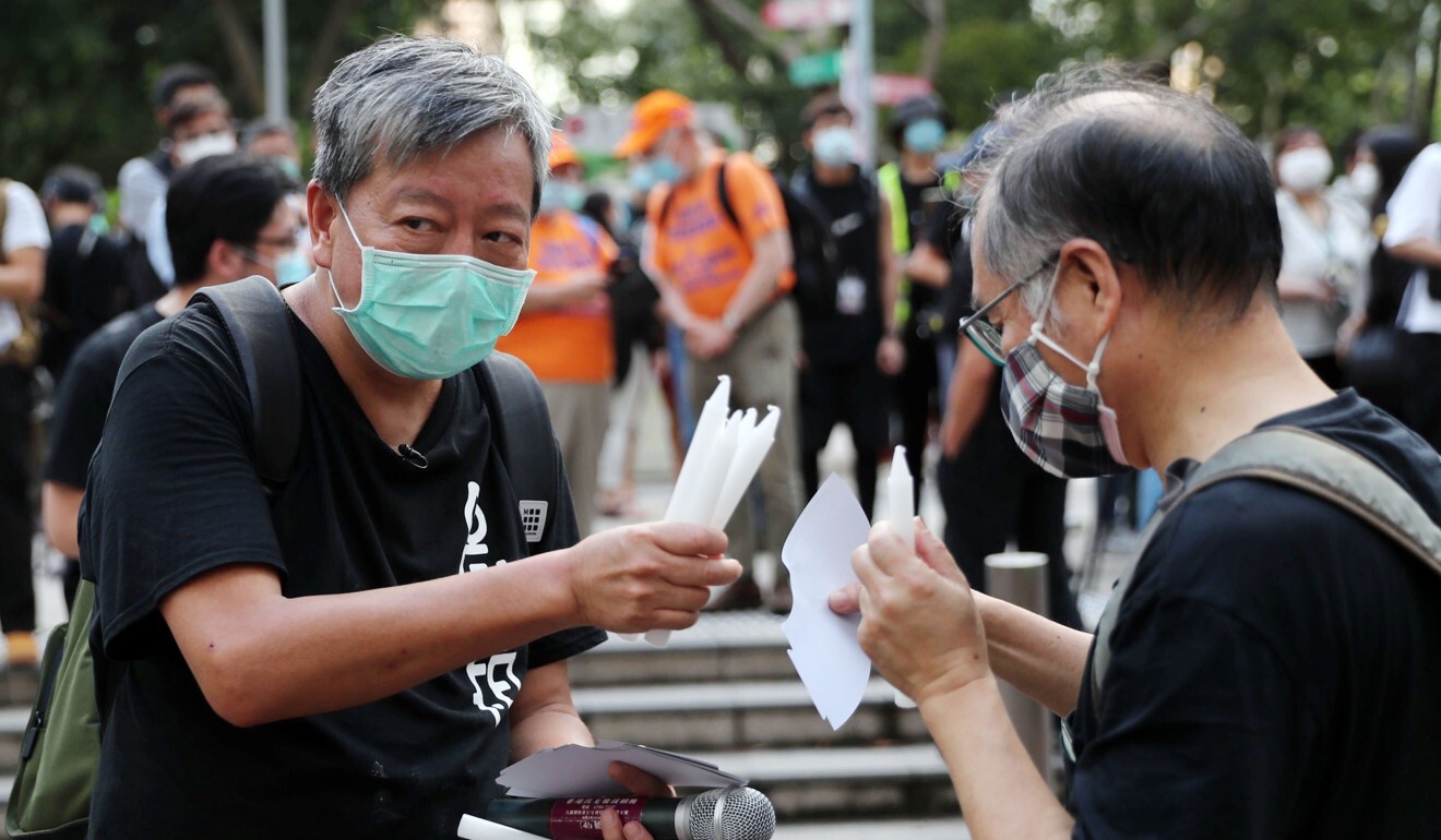The alliance’s Lee Cheuk-yan gives out candles at Victoria Park in Causeway Bay on June 4. Photo: Sam Tsang