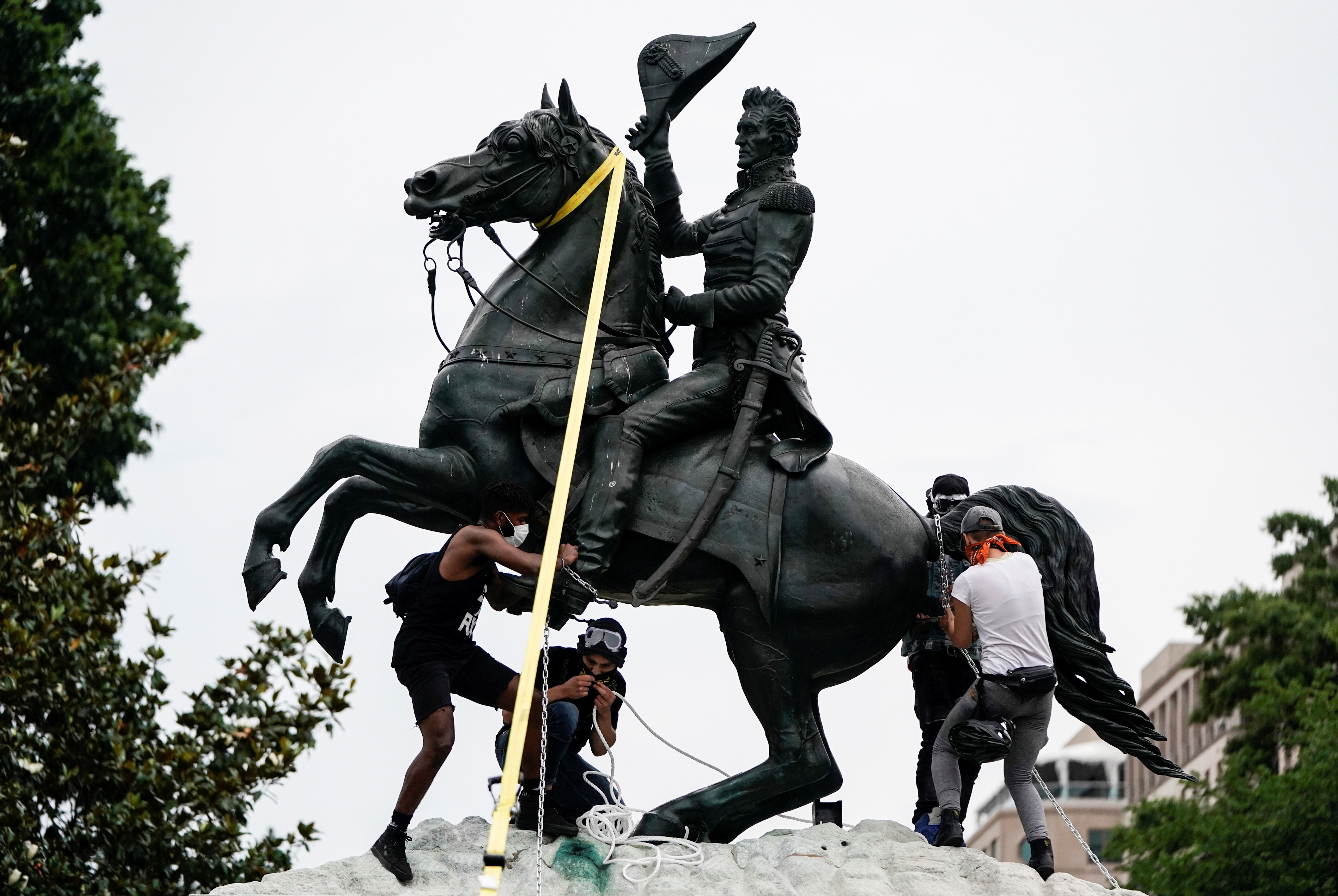 Protesters attempt to pull down the statue of former US president Andrew Jackson in the middle of Lafayette Park in front of the White House during racial inequality protests in Washington on June 22. Photo: Reuters