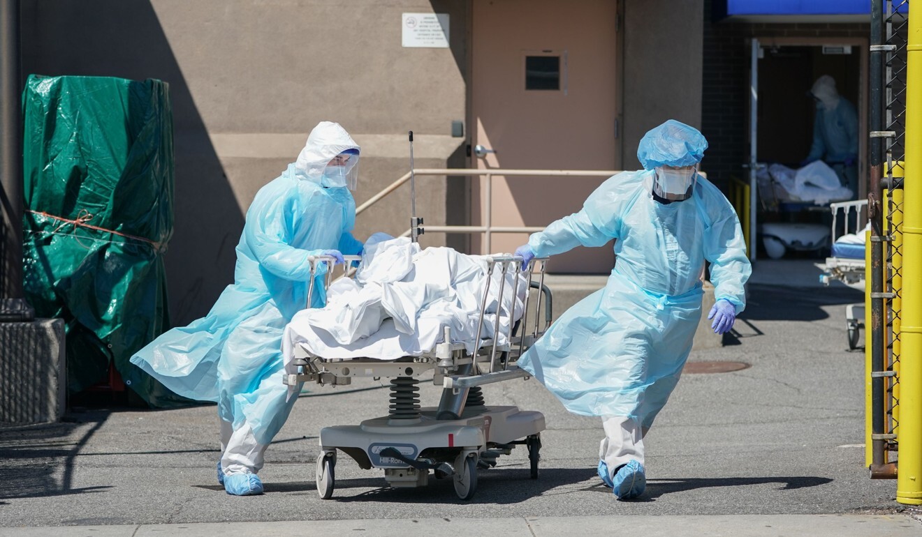 Bodies are moved to a refrigeration truck serving as a temporary morgue at the height of New York’s virus outbreak in April. Photo: AFP