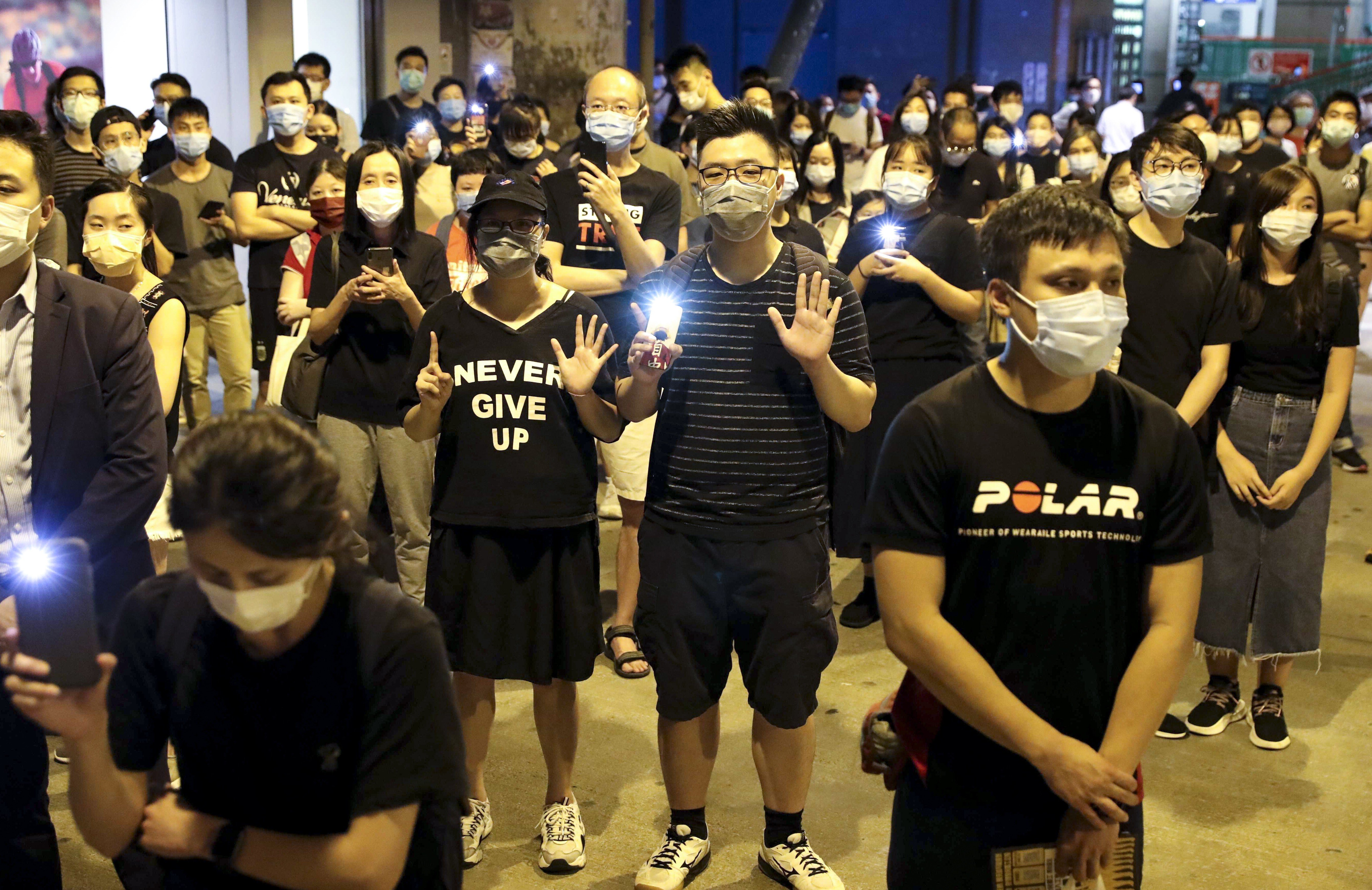 Protesters turn on the flashlight of their mobile phones as they mark the first anniversary of the anti-government movement and show their opposition to the incoming national security law for Hong Kong, at Yuen Long MTR station on June 12. Photo: Edmond So
