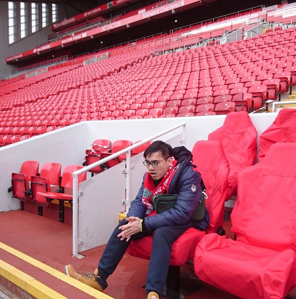 Alton Hwang sits in the home team dugout at Anfield during a visit in 2018. Photo: Handout