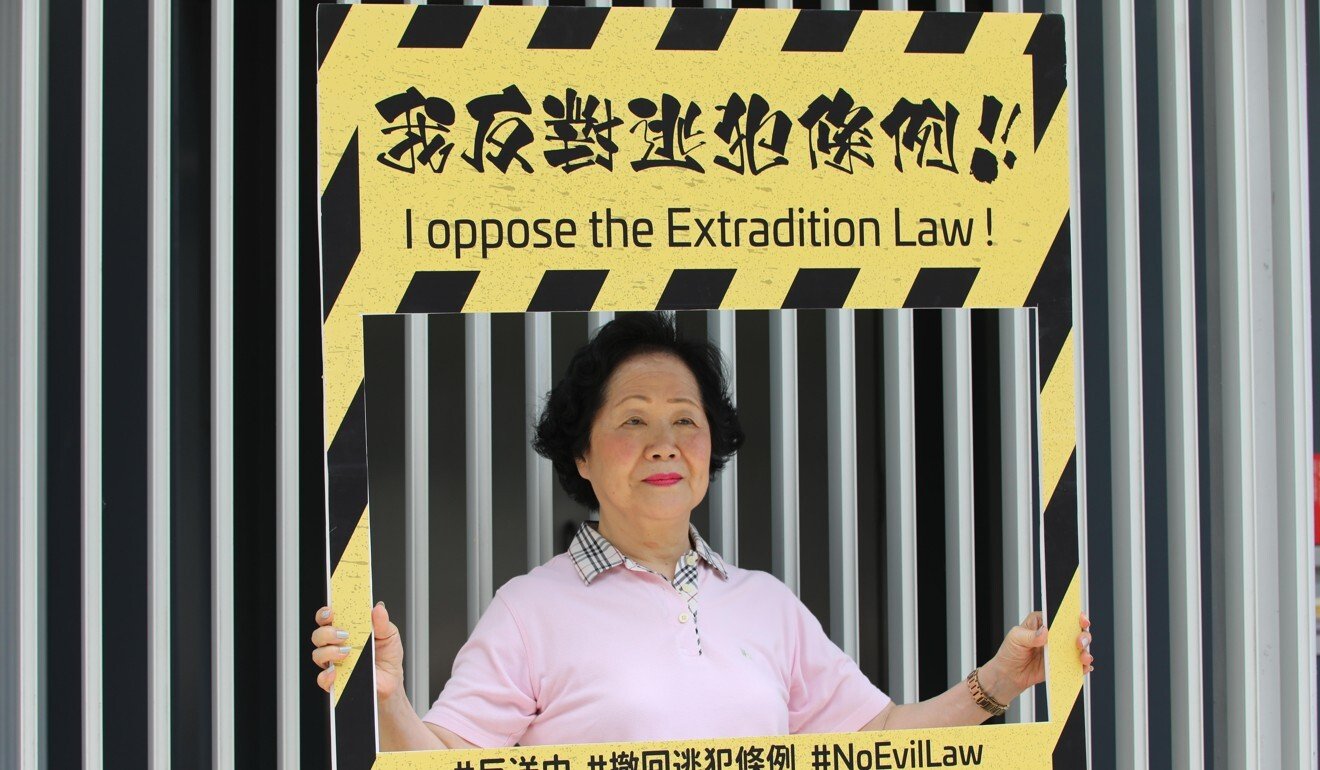 Anson Chan, who on Friday announced she was stepping back from politics, holds a sign opposing the extradition law outside government headquarters in Hong Kong’s Admiralty area in June 2019. Photo: Handout