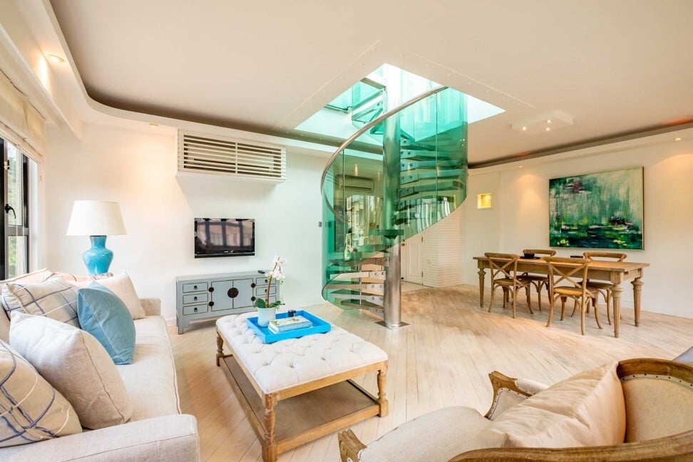 A flat in Regent Palisades in Pok Fu Lam with its existing blue glass staircase. Photo: The Home Stylist
