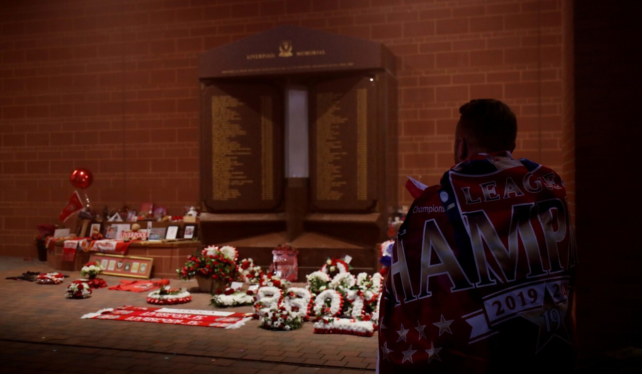 A Liverpool supporter at the Hillsborough memorial at Anfield after Liverpool win the Premier League title. Photo: Reuters
