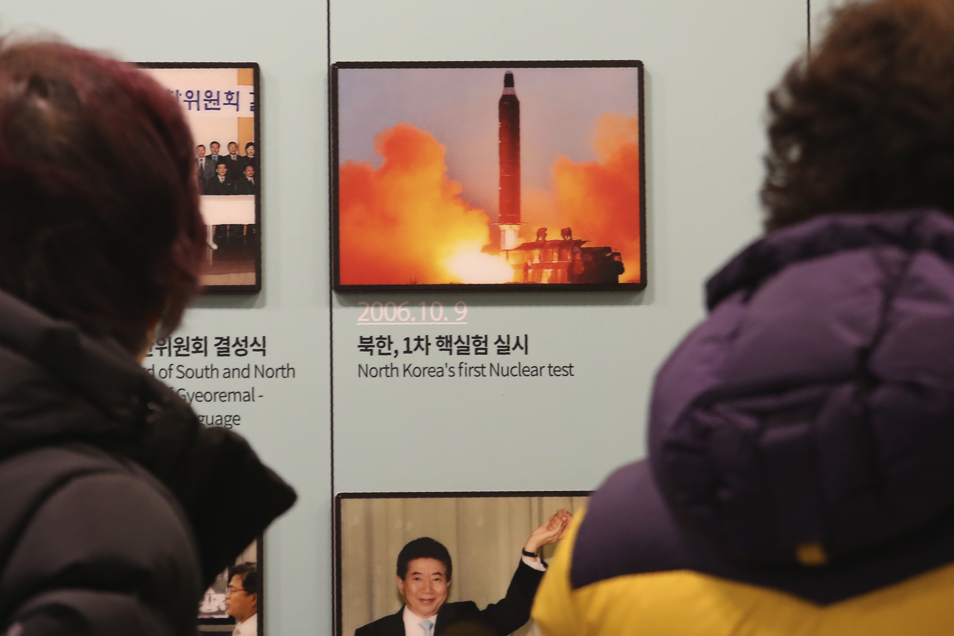 Visitors view a photo showing North Korea's missile launch at the Unification Observation Post in Paju, South Korea, on December 13, 2019. Photo: AP