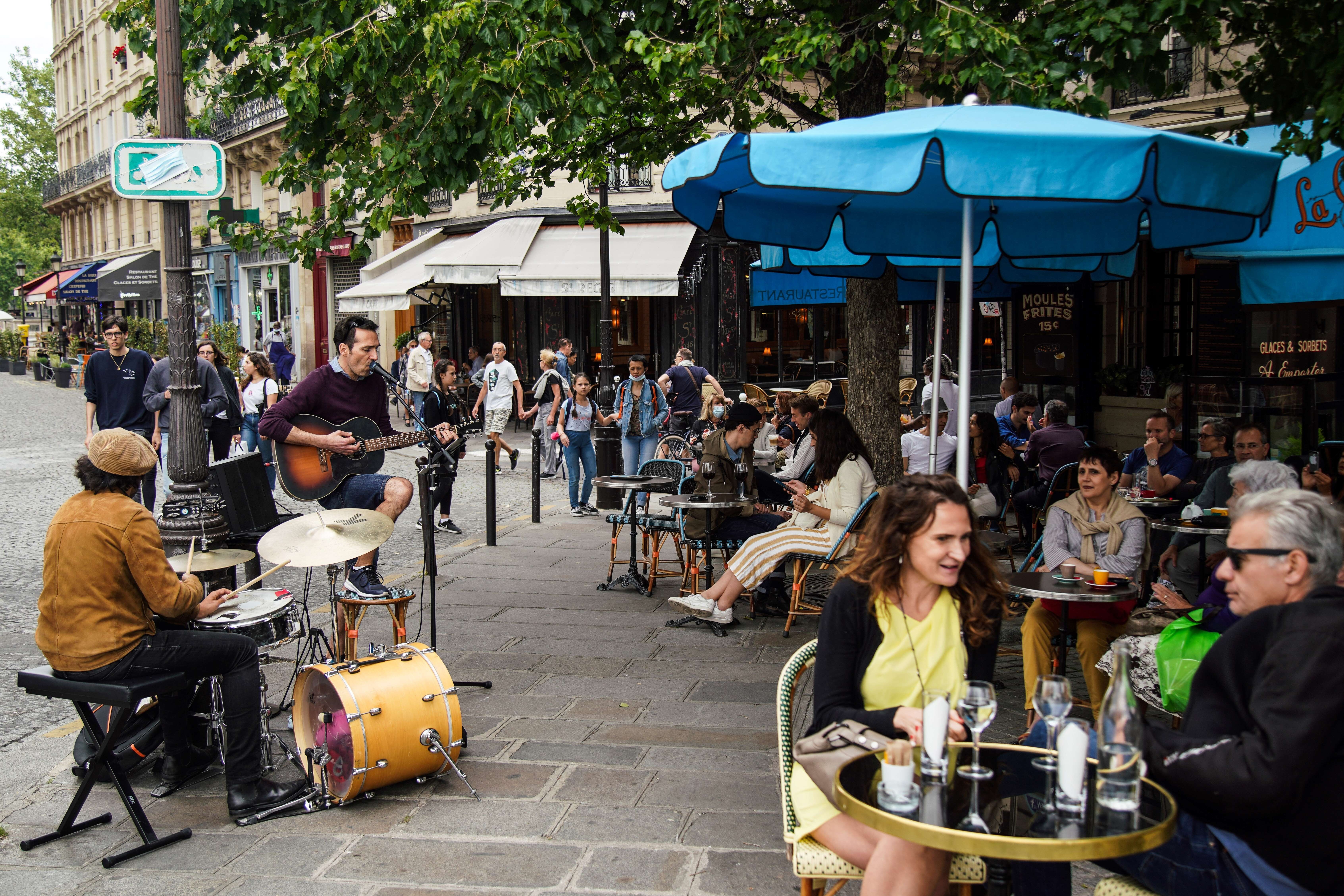 A band plays music in front of a restaurant in Paris as the city eases from Covid-19 lockdown. Photo: Abdulmonam Eassa/AFP via Getty Images