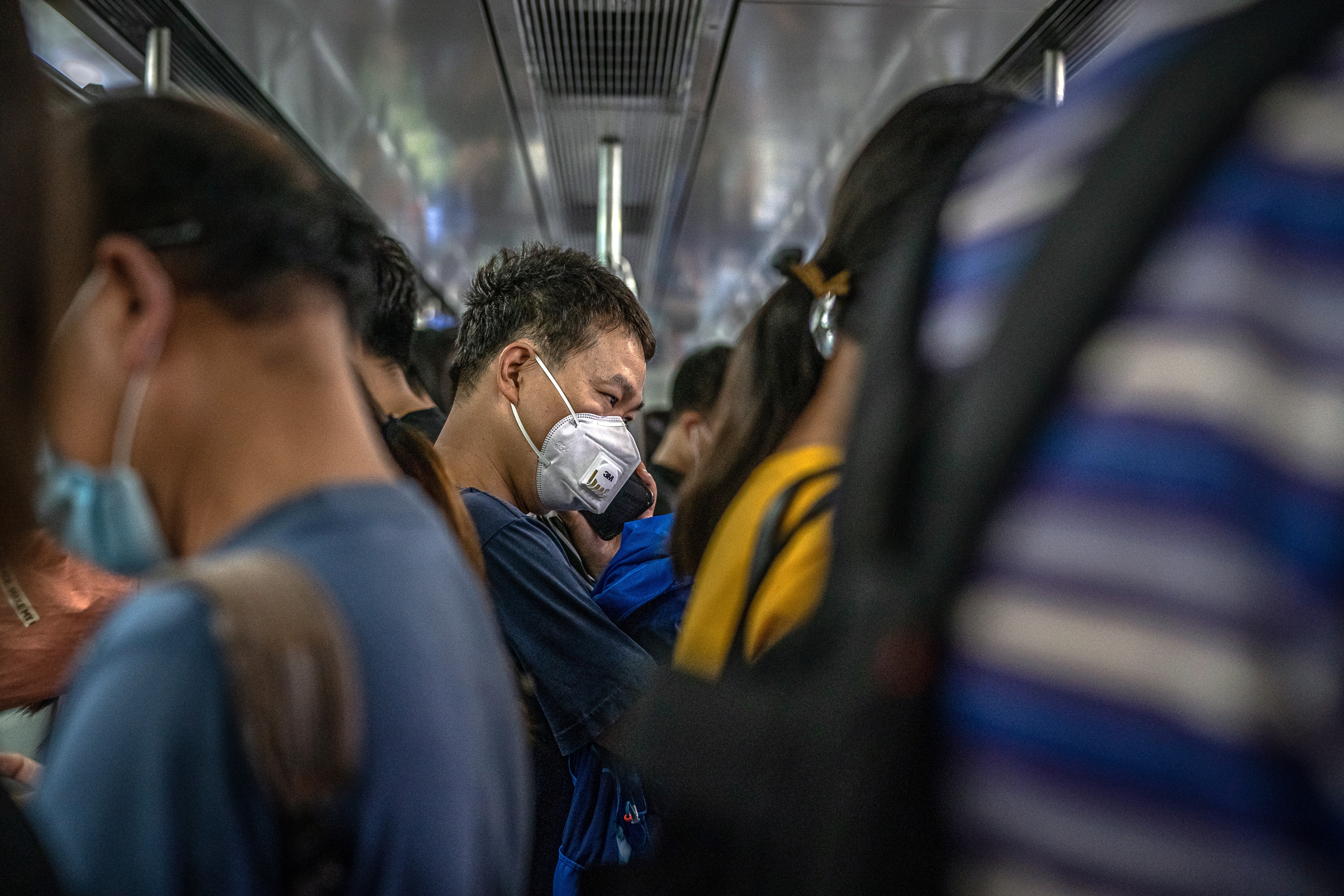 People wearing protective face masks ride the subway in Beijing during evening rush hour on June 18, a week after the city was hit by a second wave of Covid-19 infections. Passenger numbers dipped on news of the mini outbreak, but to nowhere near the lows experienced during January and February. Photo: EPA-EFE