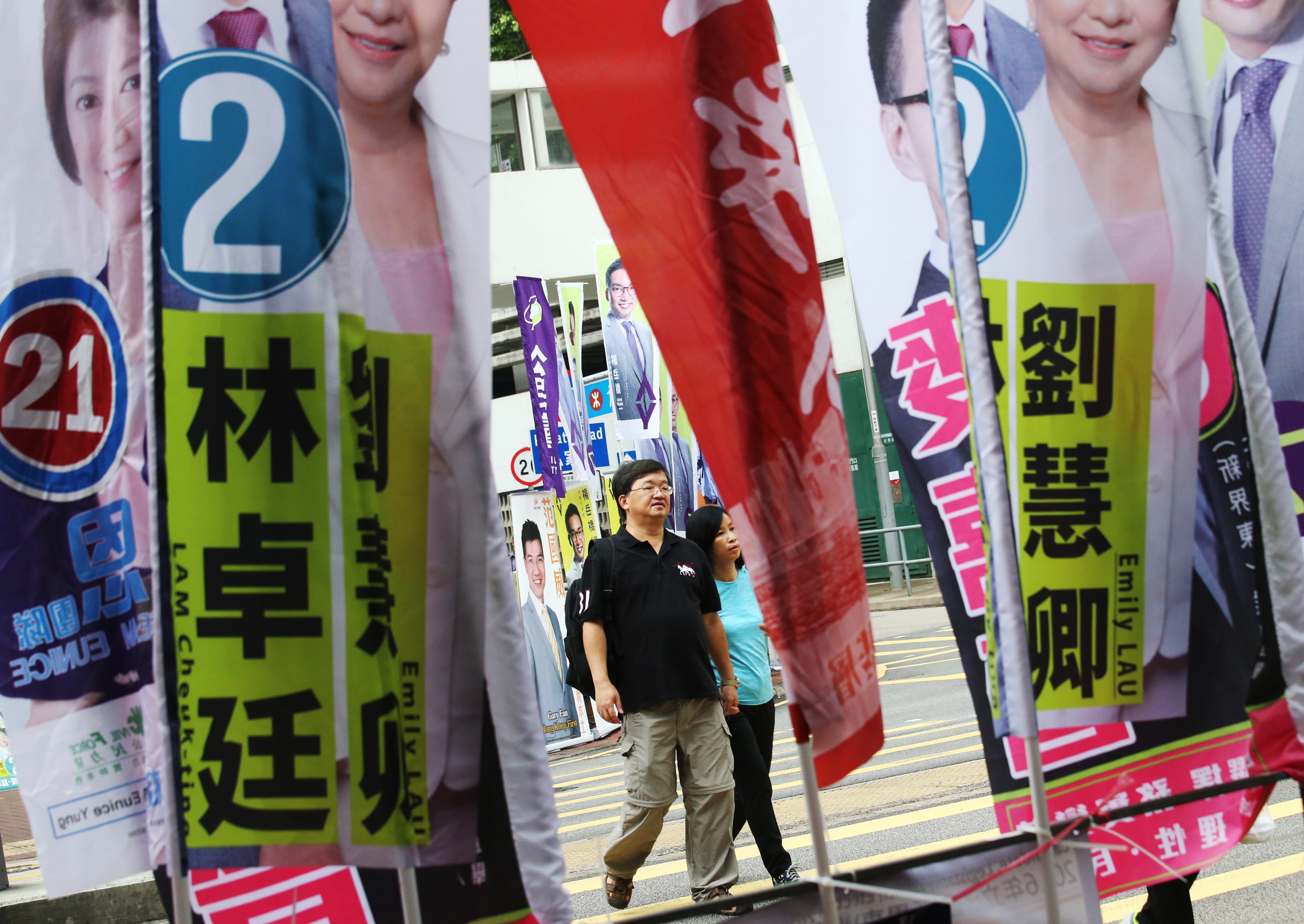 People walk towards a voting centre on a street festooned with campaign banners in Sha Tin during the previous Legco election, in September 2016. The political environment in Hong Kong has changed dramatically since then. Photo: David Wong