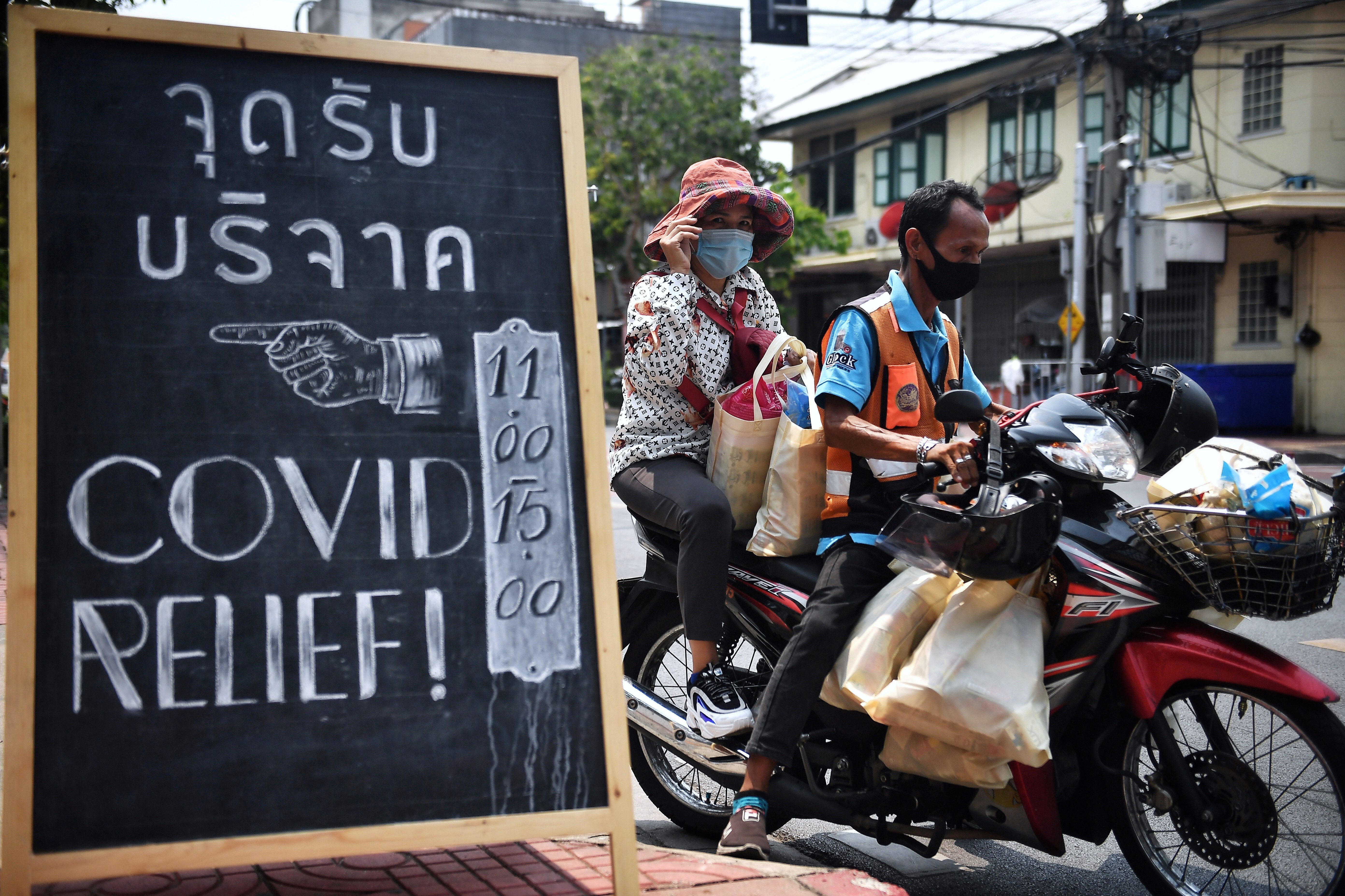 Volunteers deliver packages of food and supplies from Covid Relief Bangkok, a private collective group, to the poor and disadvantaged in the Thai capital on April 2. Photo: AFP