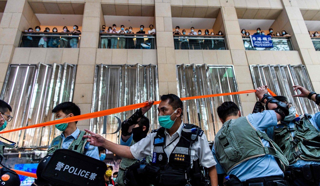 Police enter a shopping mall to disperse people attending a lunchtime rally in Hong Kong on June 30. Photo: AFP