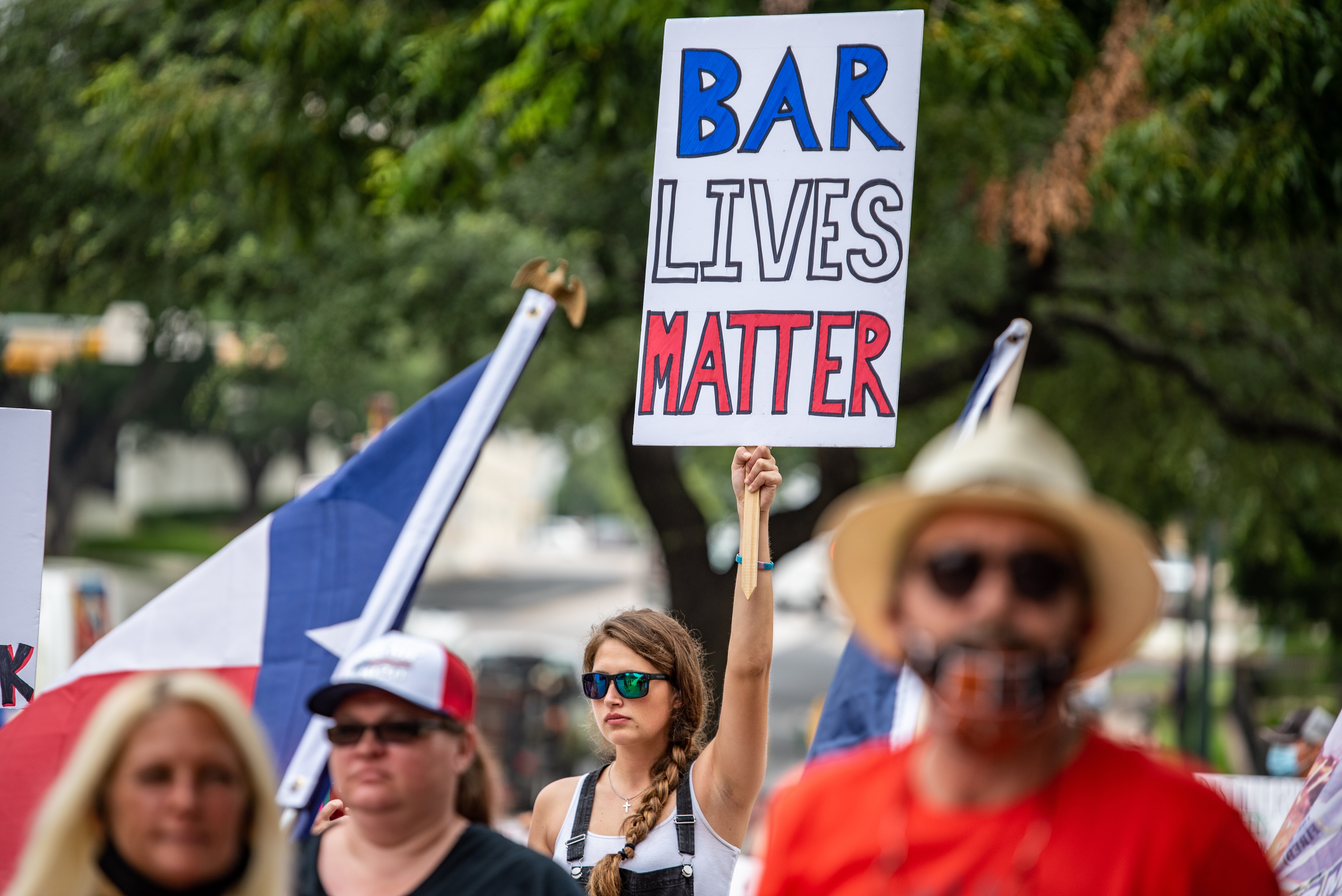 A demonstrator holds up a sign during a “Bar Lives Matter” protest in Austin, Texas. Photo: Bloomberg