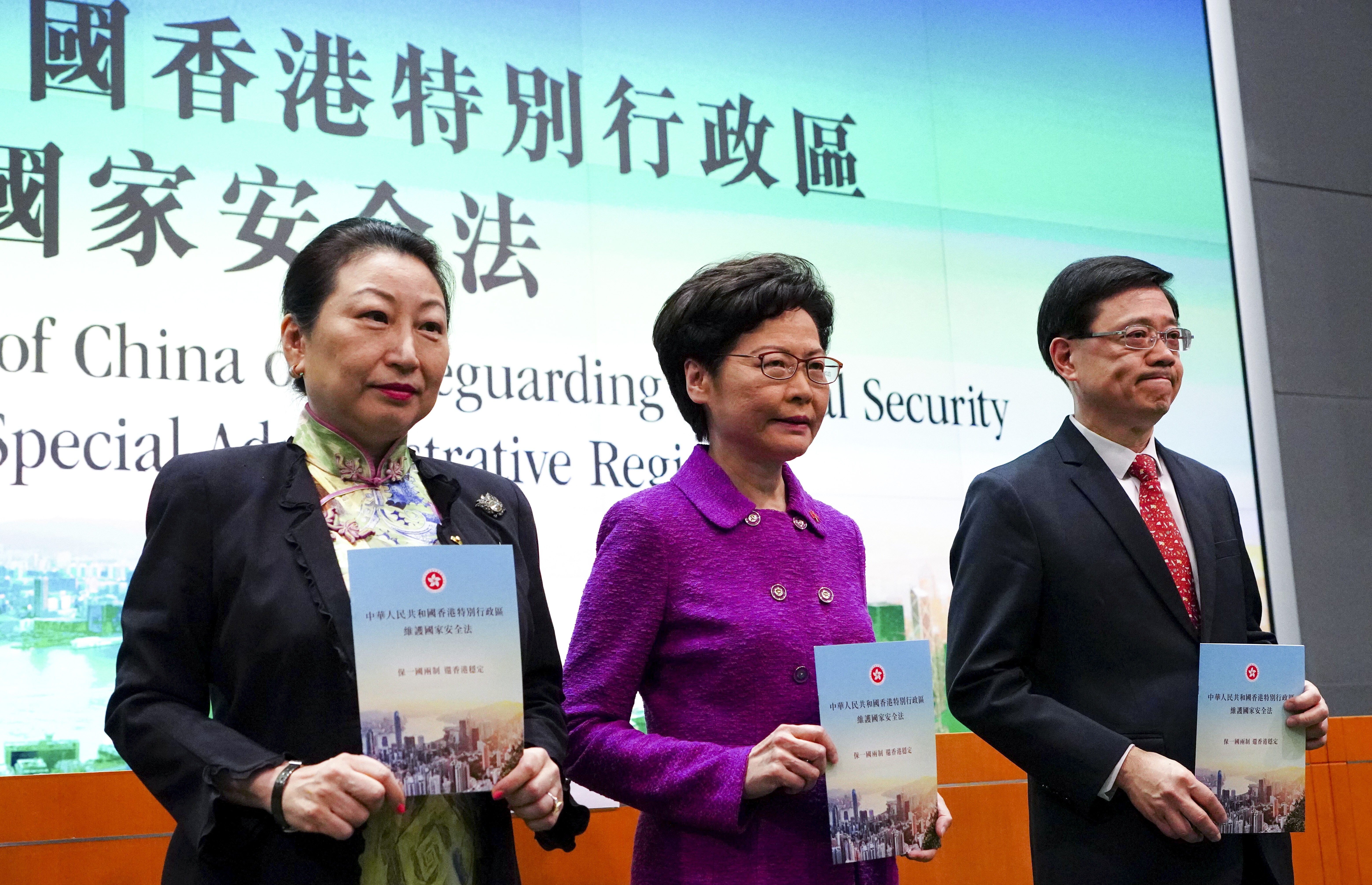Meeting the press to discuss the new national security law are, (from left) Secretary for Justice Teresa Cheng, Chief Executive Carrie Lam and Secretary for Security John Lee Ka-chiu, at the Hong Kong government headquarters on July 1. Photo: Robert Ng