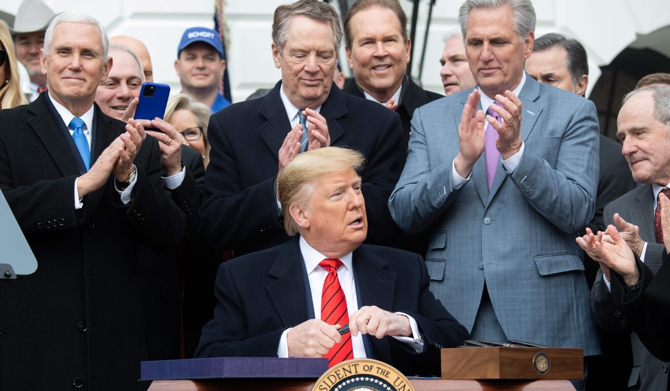 US President Donald Trump signs the USMCA on the South Lawn of the White House in January. Photo: AFP