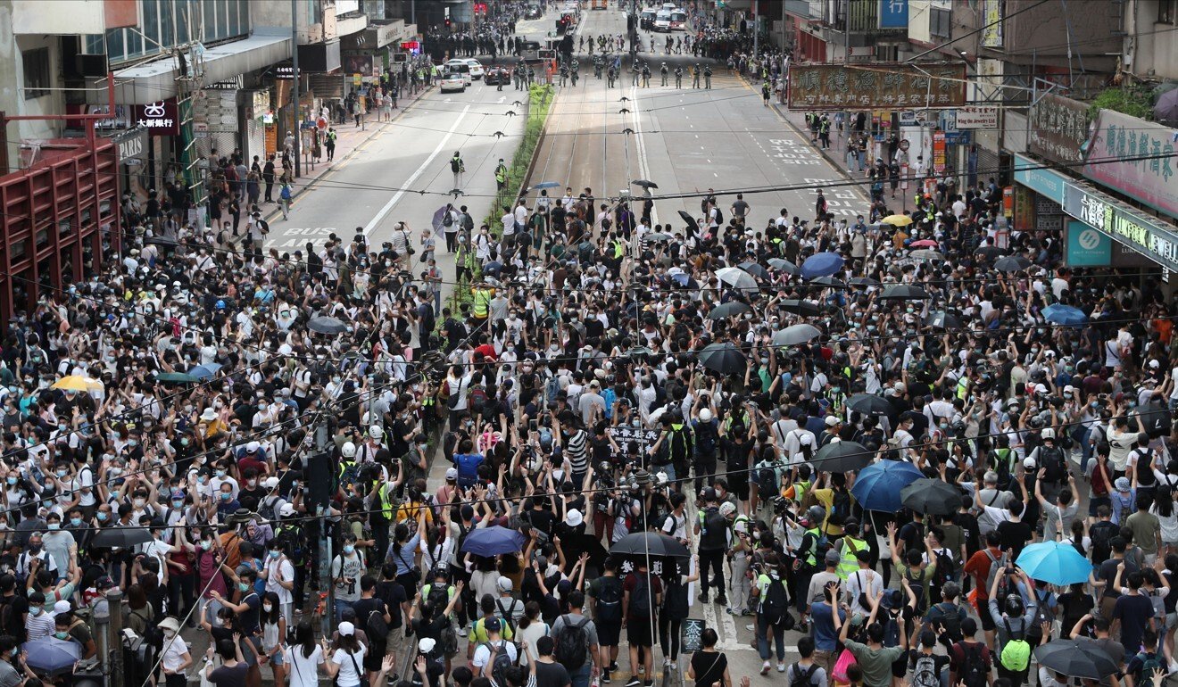 Anti-government protesters halt on Hennessy Road in Causeway Bay on July 1, the 23rd anniversary of the handover, during a march against the national security law that went ahead despite a police ban. Photo: Sam Tsang