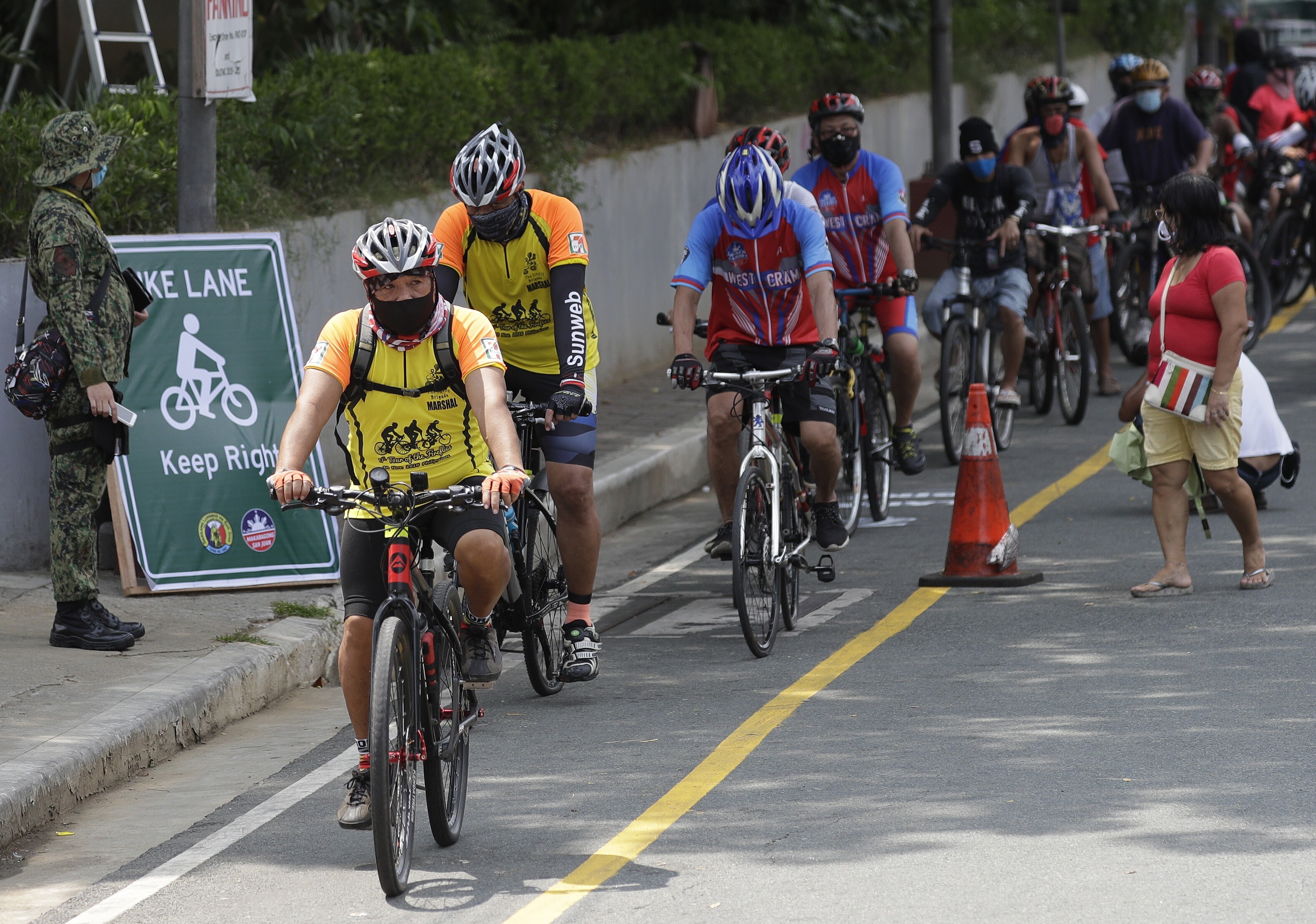 Cyclists wearing protective masks ride along a newly opened bike lane in San Juan city, Metro Manila, in observance of World Bicycle Day on June 3, 2020. Several cities have opened bicycle lanes as people use different ways of commuting while public transport remains limited to prevent the spread of Covid-19. Photo: AP